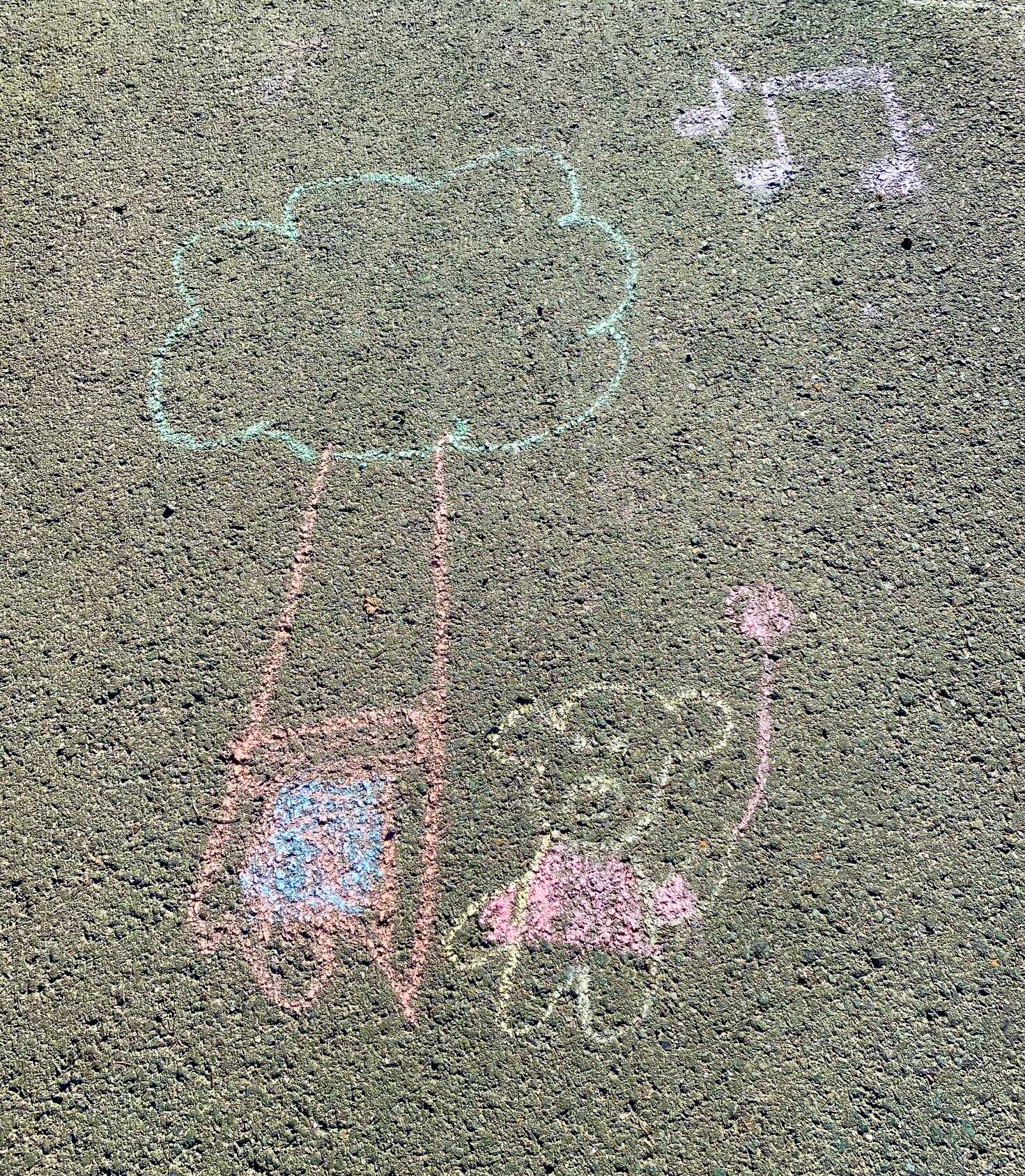 Happy days are here again as depicted in a sidewalk chalk drawing in a downtown driveway on Aug. 28. (Photo by Denise Carroll)