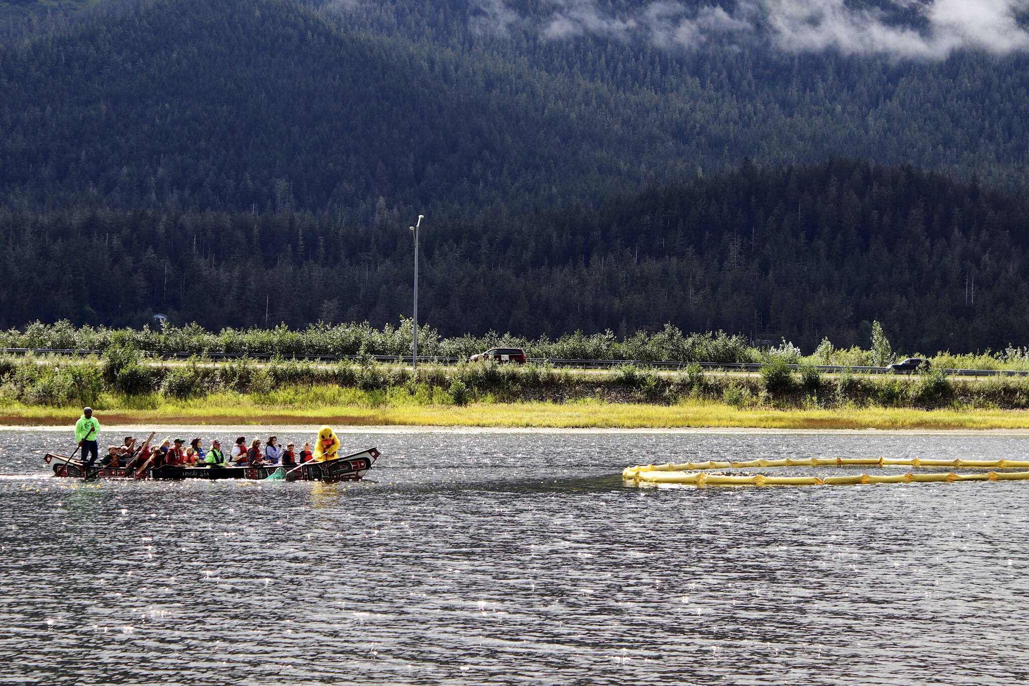 Duck mascot Freda leads a boat of people toward a large floating ring on Twin Lakes on Saturday where ducks were collected during the Glacier Valley Rotary Duck Derby on Saturday. (Meredith Jordan / Juneau Empire)