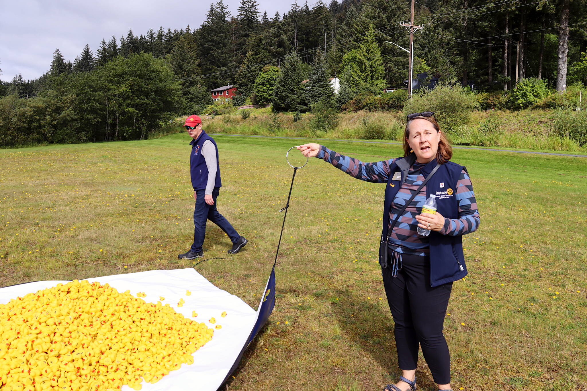 Michelle and Steve Strickler examine a net filled with rubber ducks before they are dropped from a helicopter into Twin Lakes on Saturday during the Glacier Valley Rotary Duck Derby. (Meredith Jordan / Juneau Empire)