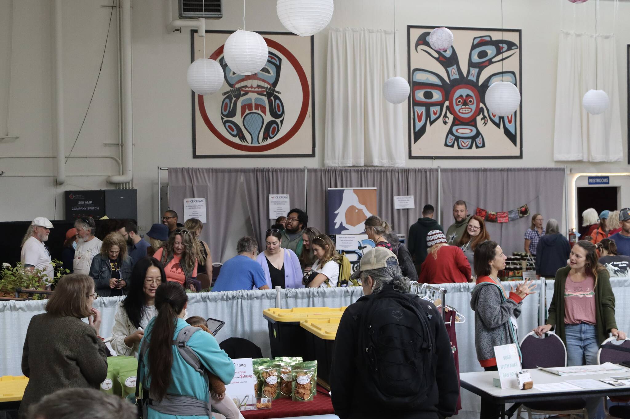 Food and other items are offered to people inside the Juneau Arts & Culture Center during the Annual Food Festival & Farmer’s Market on Saturday. (Meredith Jordan / Juneau Empire)
