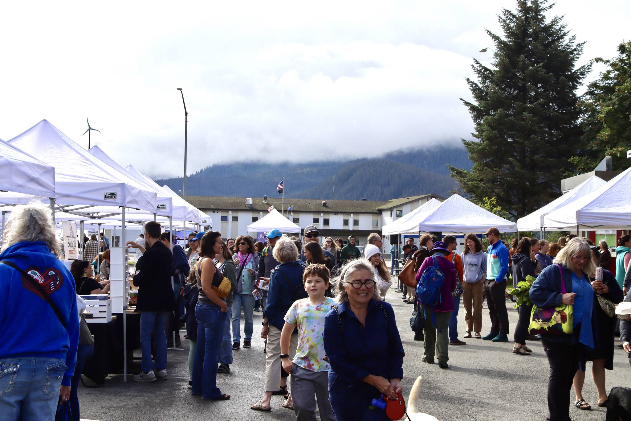 People explore the vendor tents in the parking lot of the Juneau Arts & Culture Center during the Annual Food Festival & Farmer’s Market on Saturday. (Meredith Jordan / Juneau Empire)