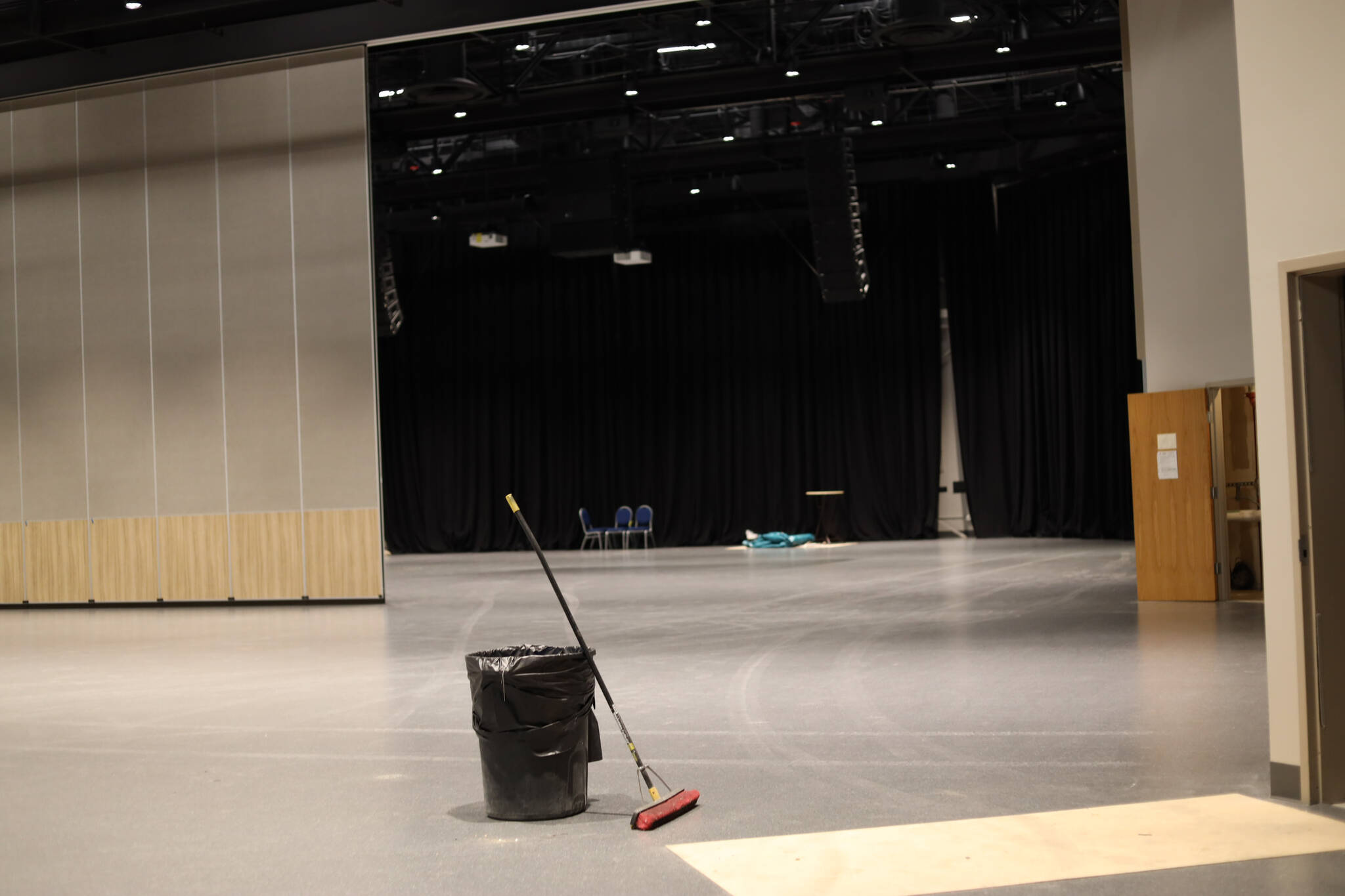 A broom and garbage bin sits in the middle of the newly renovated Centennial Hall. (Clarise Larson / Juneau Empire)