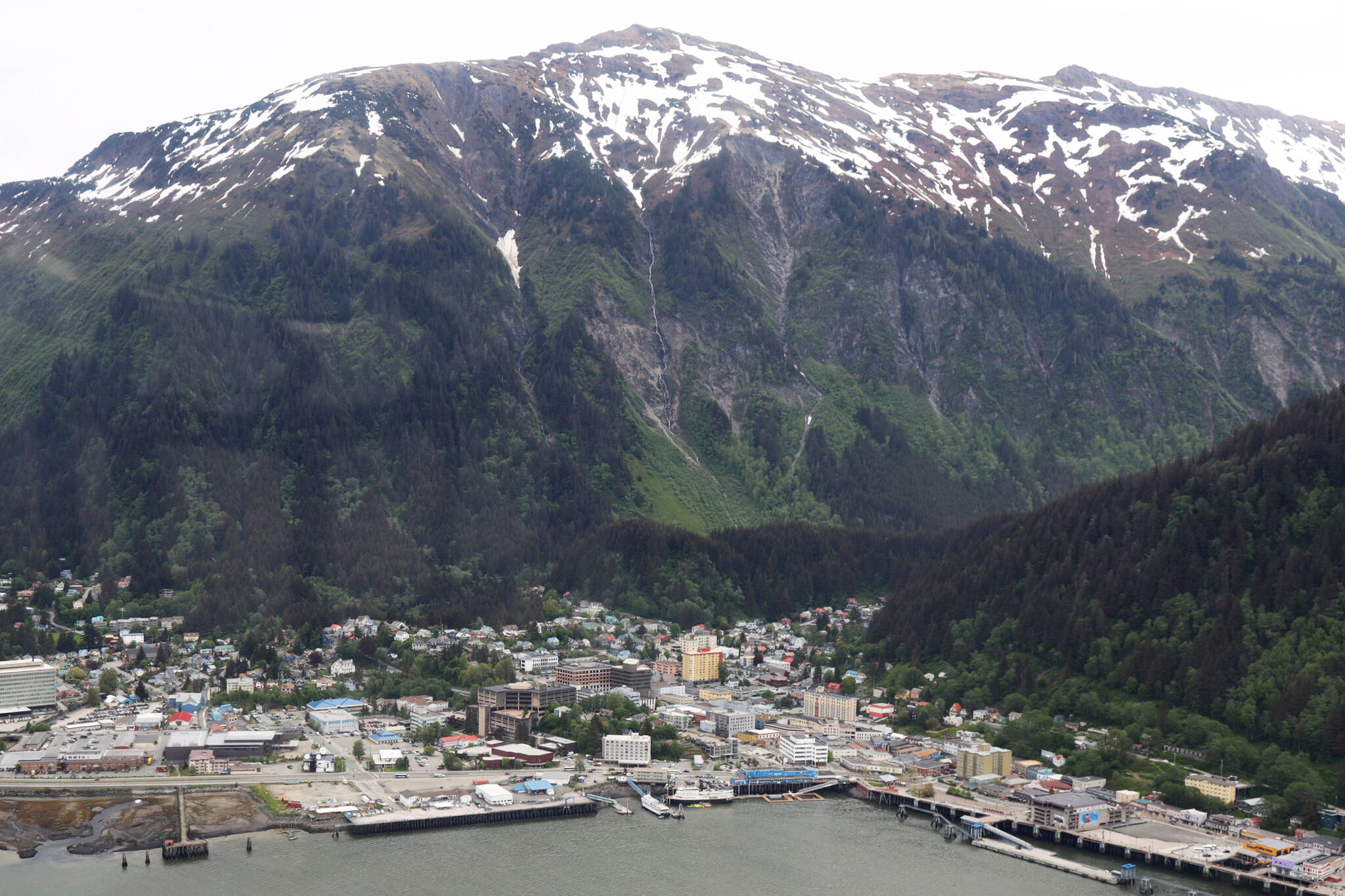 Mountains tower over downtown Juneau in late May. (Clarise Larson / Juneau Empire File)