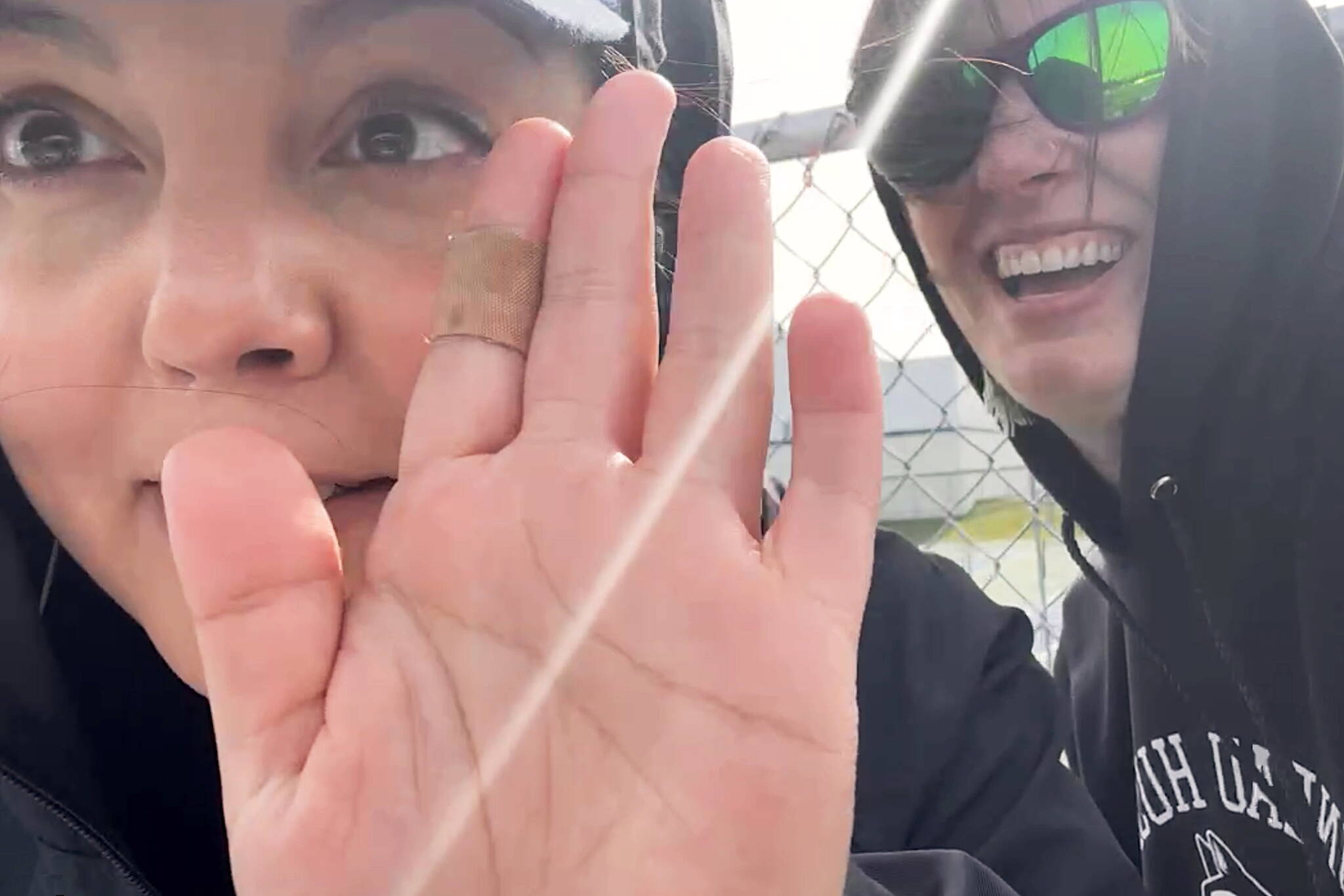 Angela Boyd and Tiffany Ridle offer a selfie greeting to viewers as they test their livestream camera before the kickoff of the Juneau Huskies game against Service High School on Saturday in Anchorage. (Screenshot from Juneau Huskies livestream video).