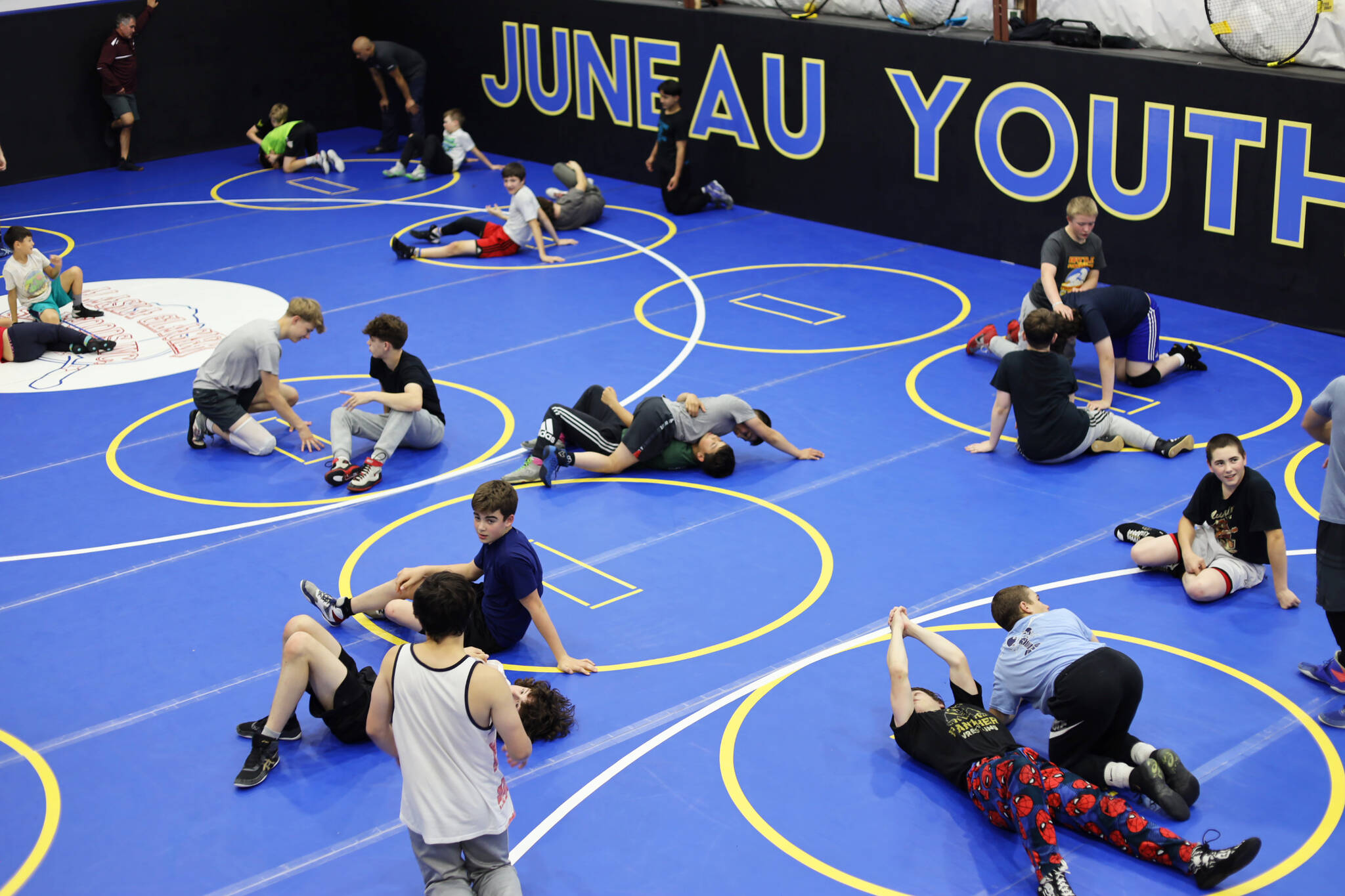 Athletes practice new moves while wrestling during a Labor Day weekend clinic at the Juneau Youth Wrestling Club’s new building on Monday. (Clarise Larson / Juneau Empire)