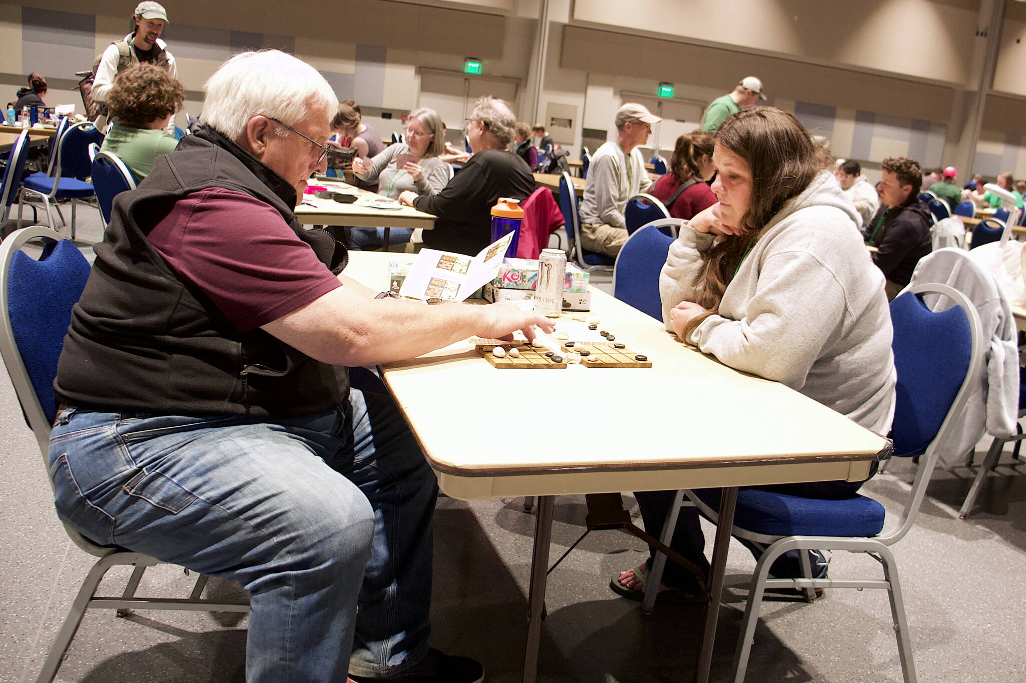 Bryan Wilson and Courtney Olivia engage in the ancient game of Shōbu on Saturday during the annual Platypus-Con Board and Card Game Extravaganza at Centennial Hall. The event continues through Sunday. (Mark Sabbatini / Juneau Empire)
