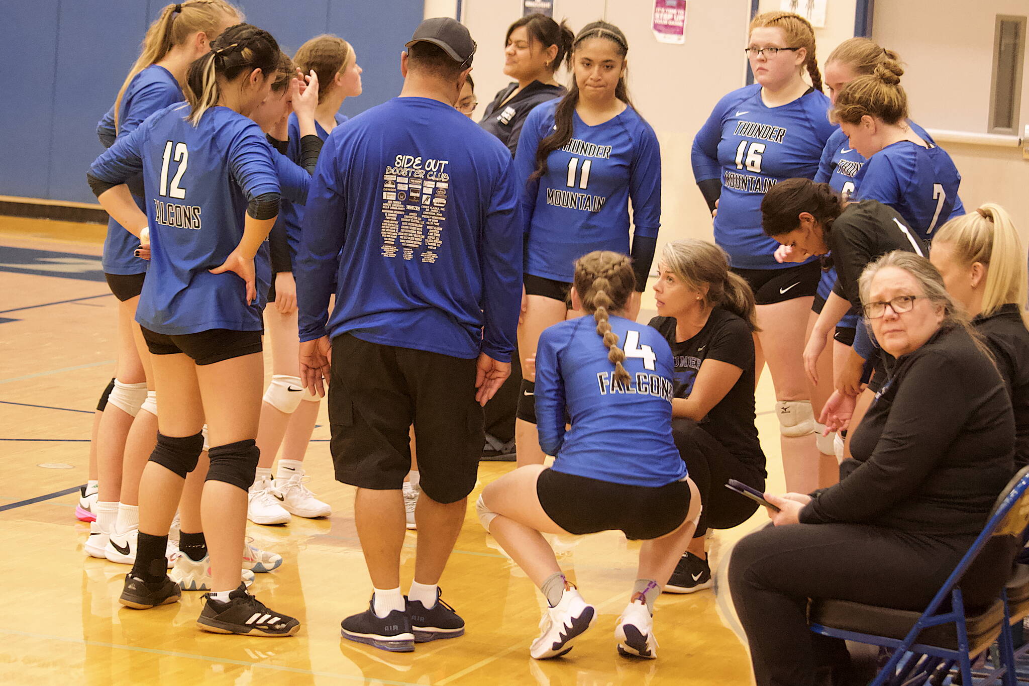 Thunder Mountain High School coach Julie Herman huddles with her players during a timeout in the team’s five-game set against Ketchikan High School on Saturday night at TMHS. (Mark Sabbatini / Juneau Empire)