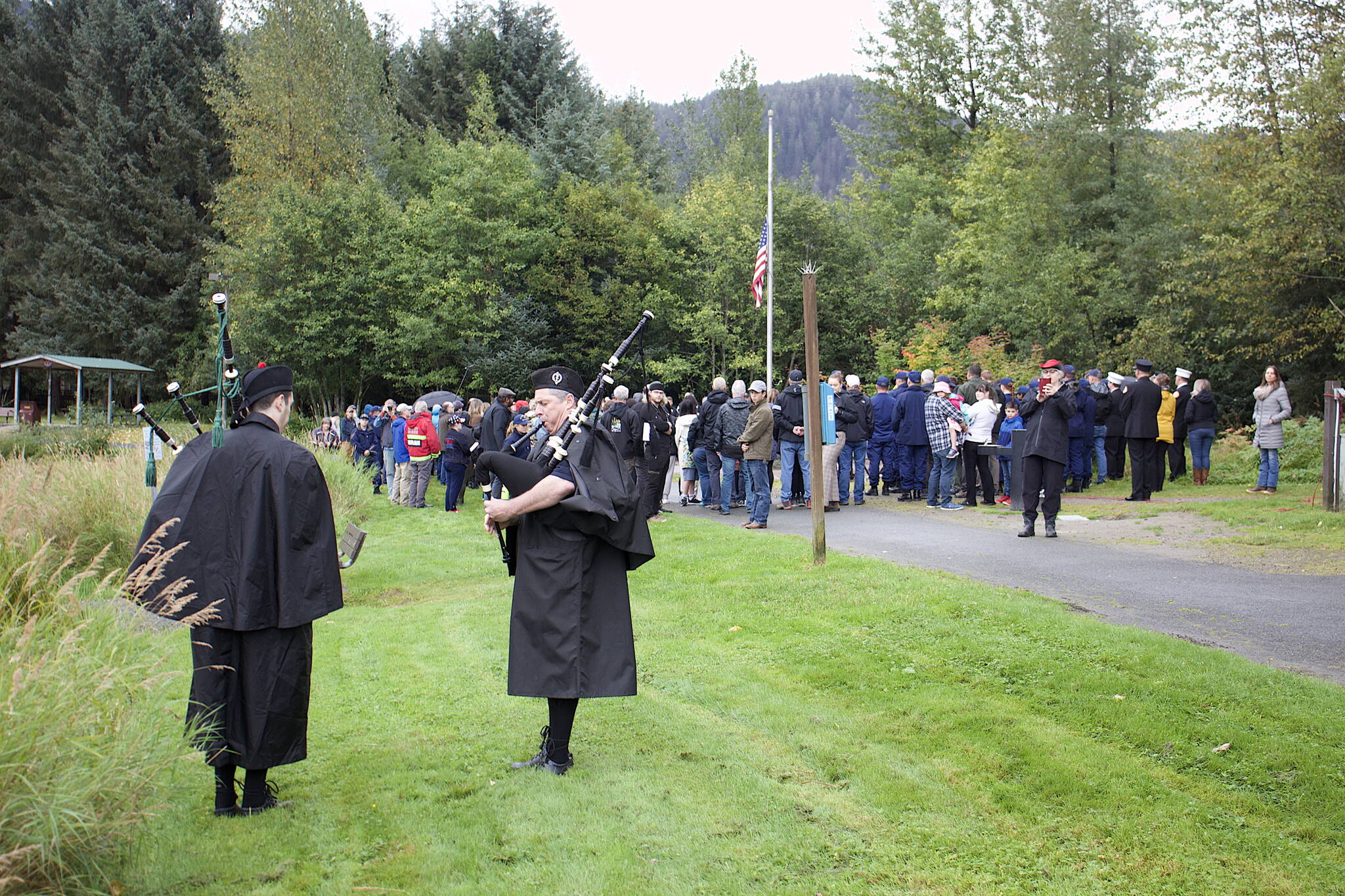 Jake Marnon (left) and his father Scott play “Amazing Grace” at the conclusion of a ceremony Monday at the September 11th Memorial at Riverside Rotary Park commemorating the terrorist attacks on that date in 2001. (Mark Sabbatini / Juneau Empire)