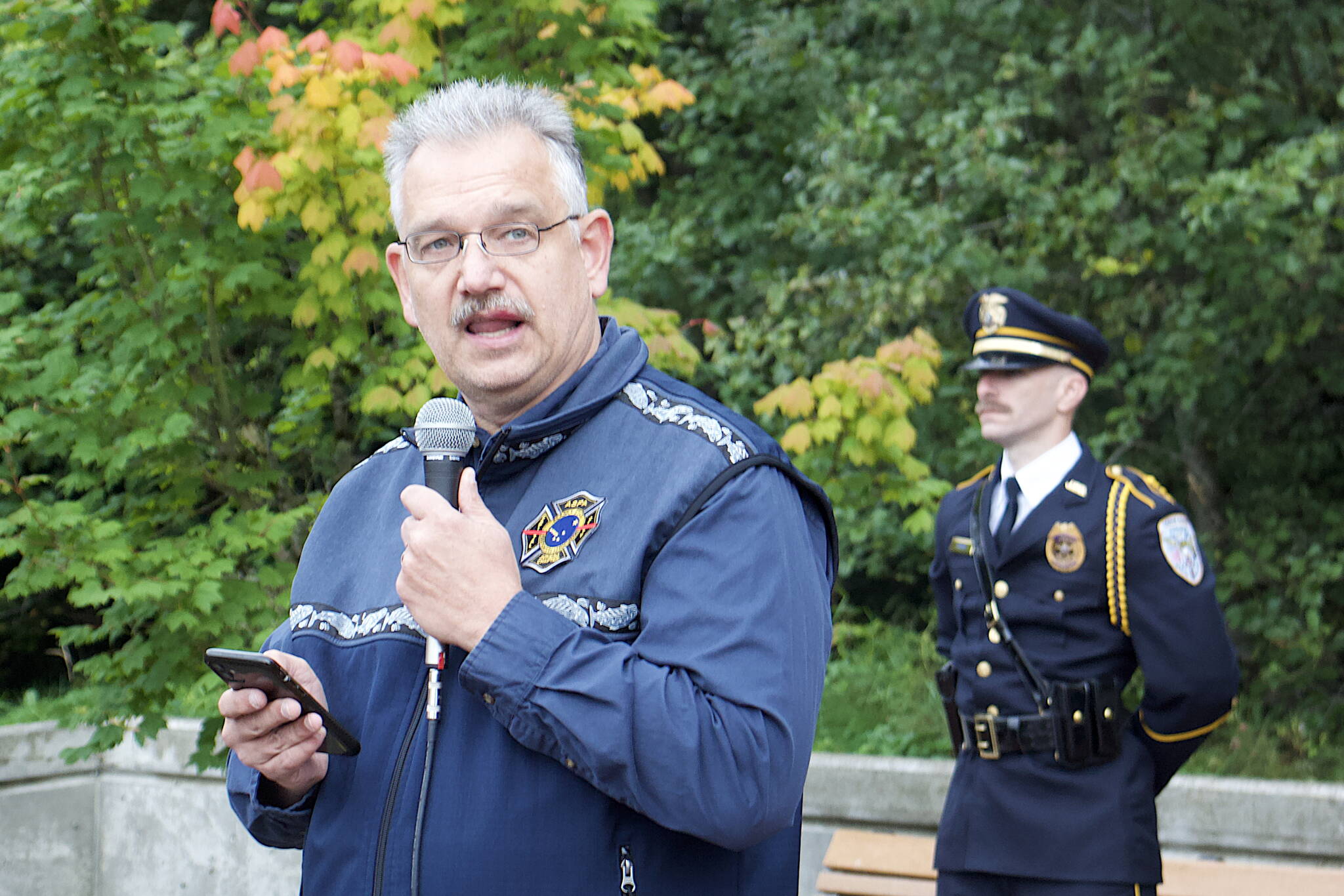 Michael Pierson, a Capital City Fire/Rescue firefighter, delivers an “invitation to remember” speech during a ceremony Monday at the September 11th Memorial at Riverside Rotary Park commemorating the terrorist attacks on that date in 2001. (Mark Sabbatini / Juneau Empire)