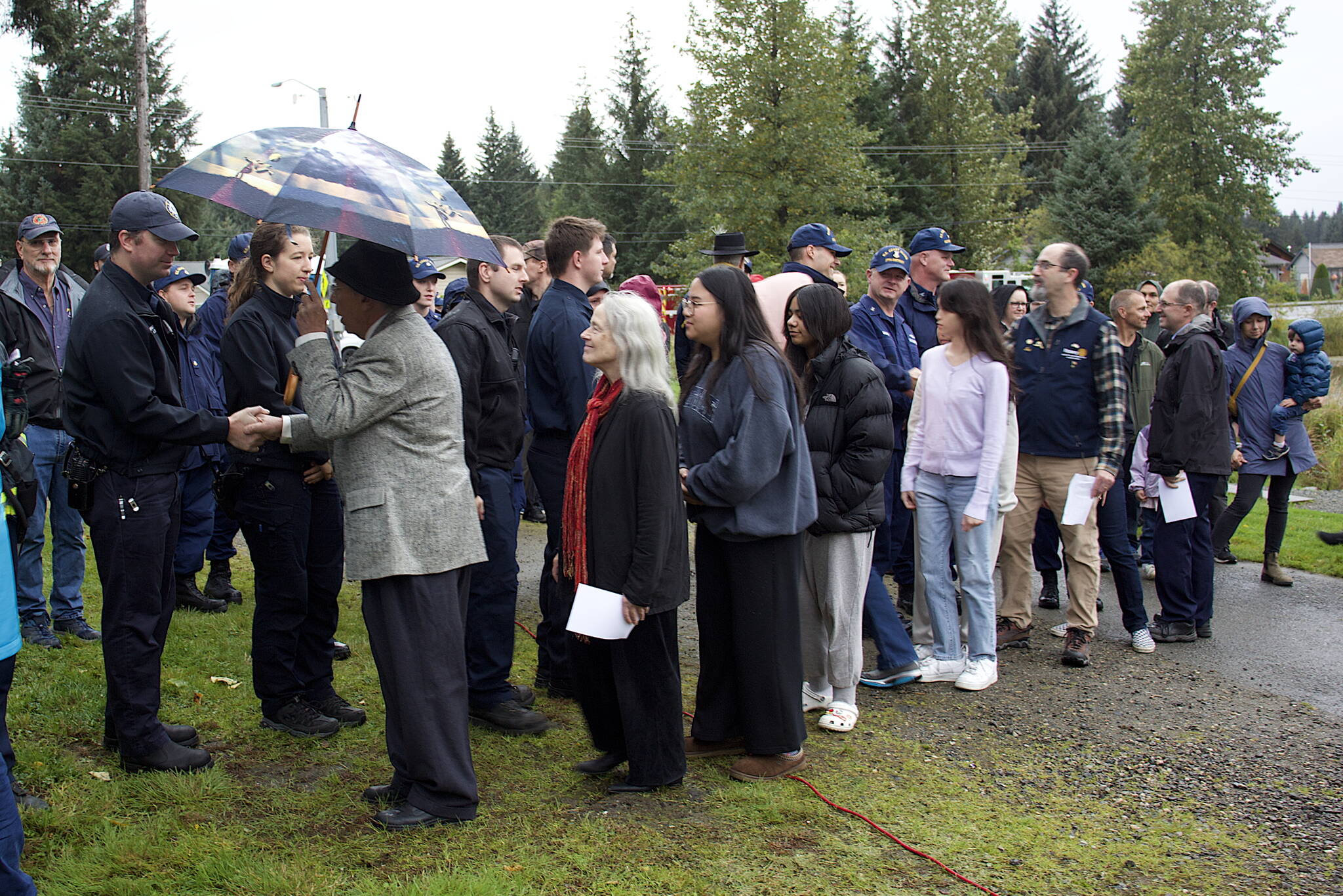 Juneau residents line up to thank local firefighters for their service during a ceremony Monday at the September 11th Memorial at Riverside Rotary Park commemorating the terrorist attacks on that date in 2001. (Mark Sabbatini / Juneau Empire)