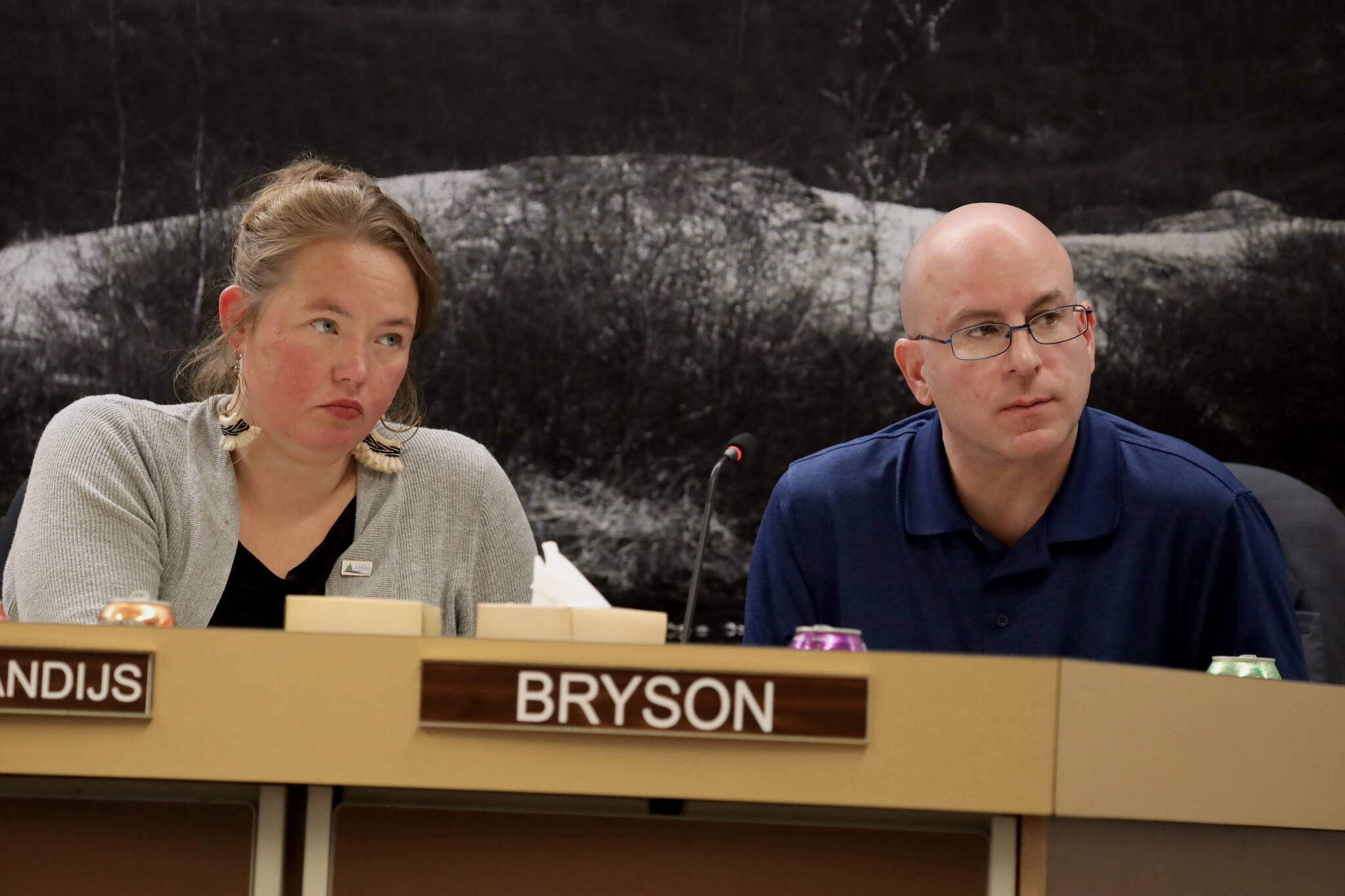 City and Borough of Juneau Assembly members Alicia Hughes-Skandijs and Wade Bryson listen to public testimony Monday night about whether the city should adopt new maps that show updated landslide and avalanche risk downtown. (Clarise Larson / Juneau Empire)
