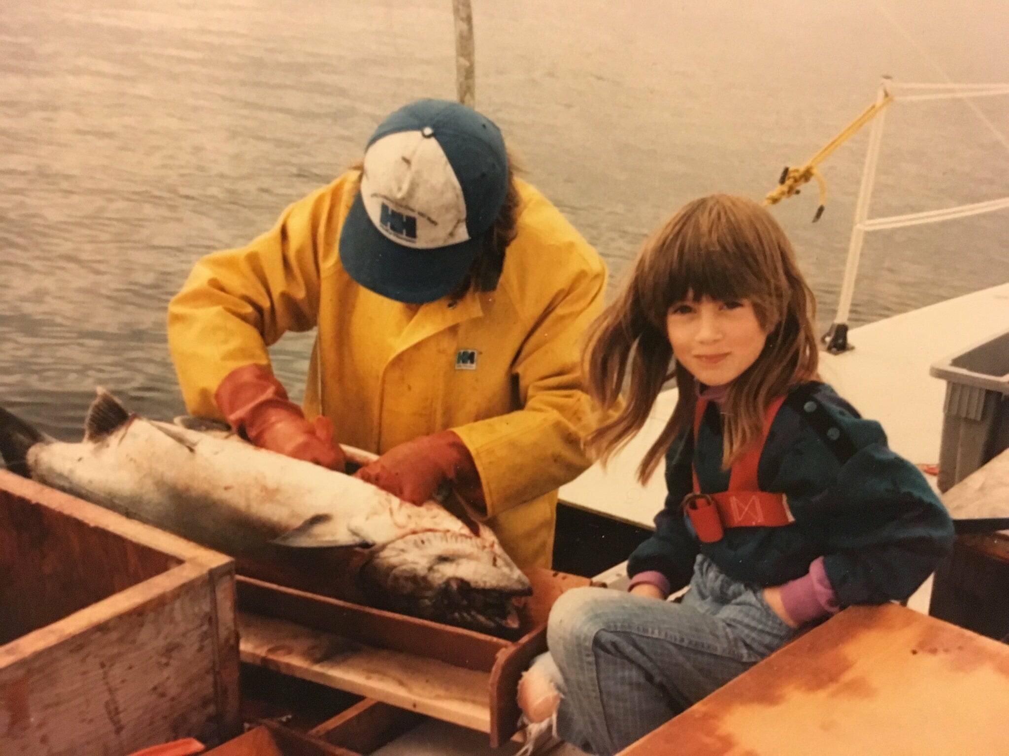 A young Tele Aadsen with her father Ken Aadsen on the family’s 40-foot trimaran hand troller in 1985. Aadsen, a commercial fisher and author of “What Water Holds,” will be visiting Hearthside Books downtown at 6 p.m. on Sunday, Sept. 17. (Photo courtesy Val Aadsen)