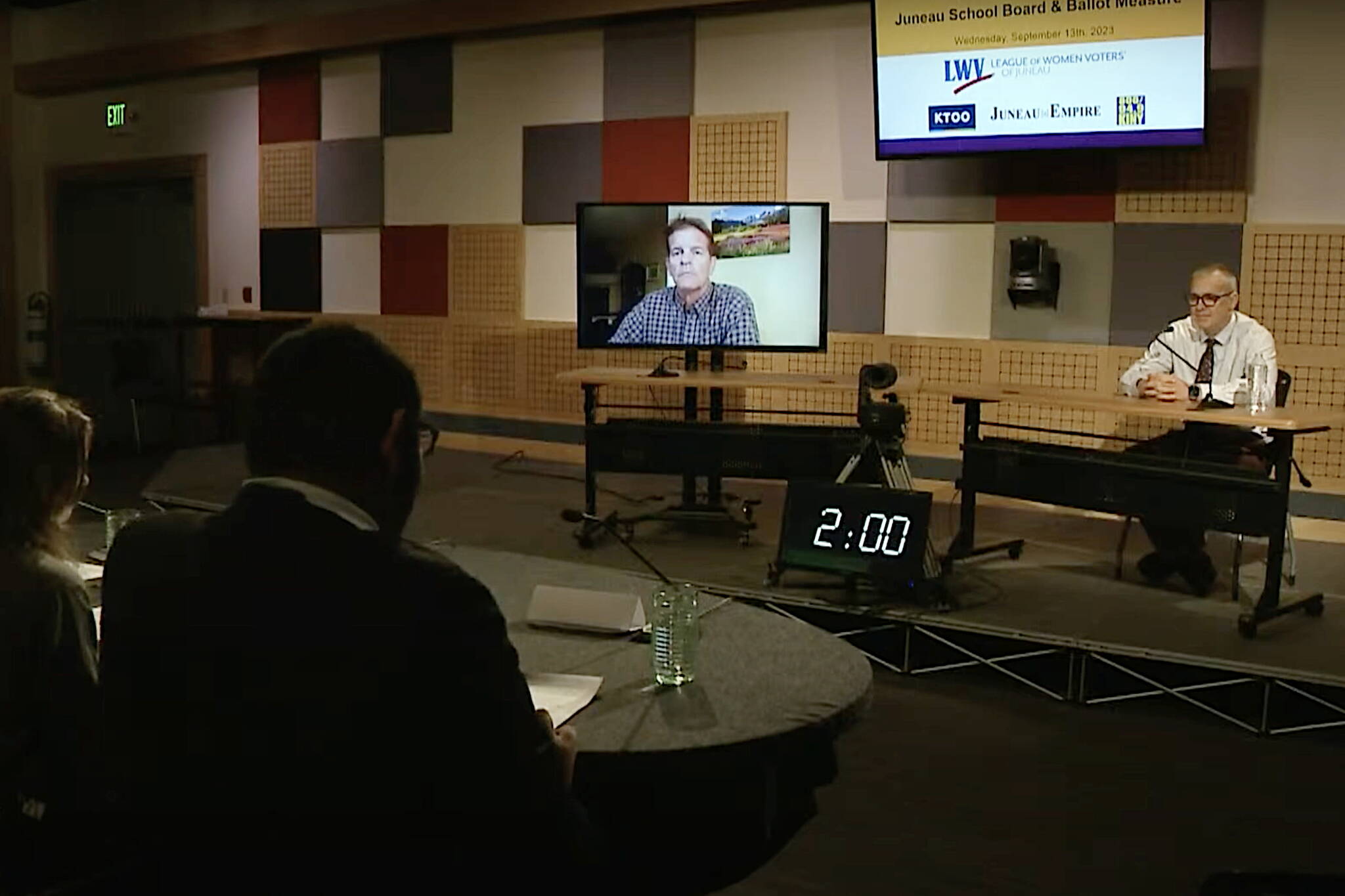 Juneau resident David Ignell, seen via video link, and departing City Manager Rorie Watt discuss a ballot measure asking voters to approve $27 million toward a new City Hall during a forum Wednesday night at the KTOO studio. (Screenshot from official video of forum)
