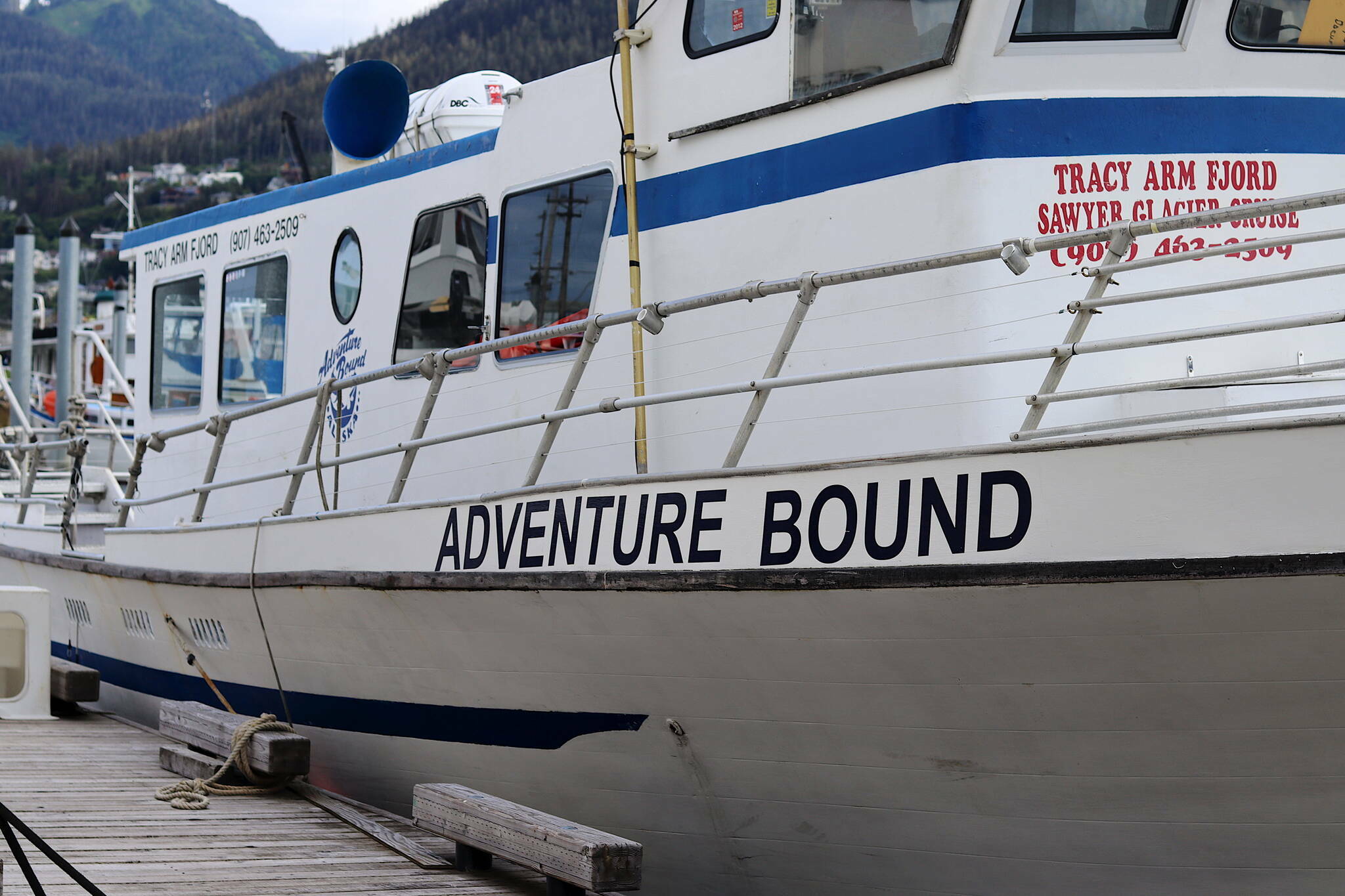 The Adventure Bound tour boat is seen here docked at Aurora Harbor in July. The vessel’s owner-operator was given four notices of deficiencies last year, but continued to operate, according to a U.S. Coast Guard report that also raises questions about the agency’s handling of a grounding incident involving the company. (Meredith Jordan / Juneau Empire File)