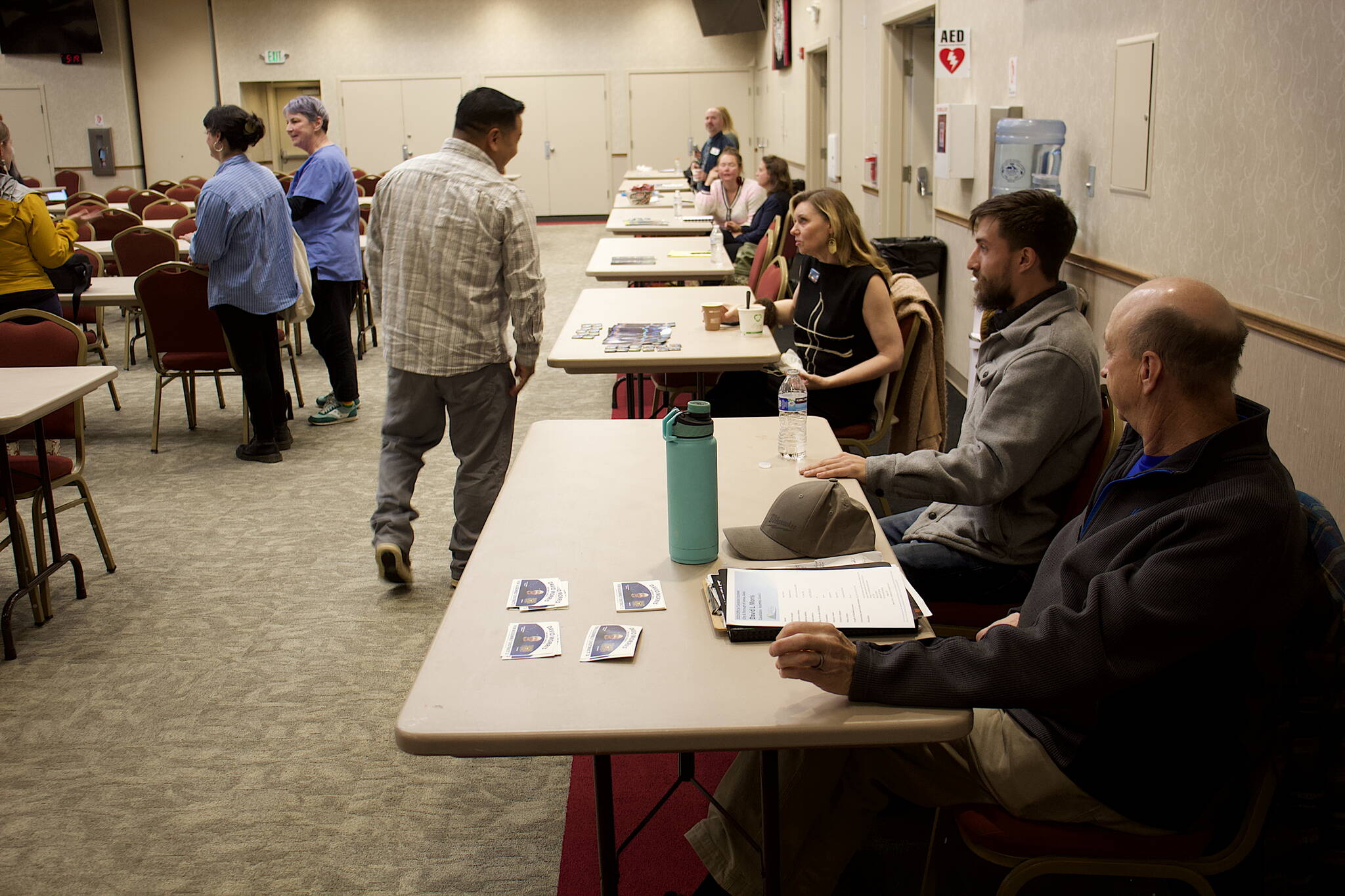 Juneau Assembly candidate talk to prospective voters at Elizabeth Peratrovich Hall before Friday night’s forum hosted by The Central Council of the Tlingit and Haida Indian Tribes of Alaska. (Mark Sabbatini / Juneau Empire)