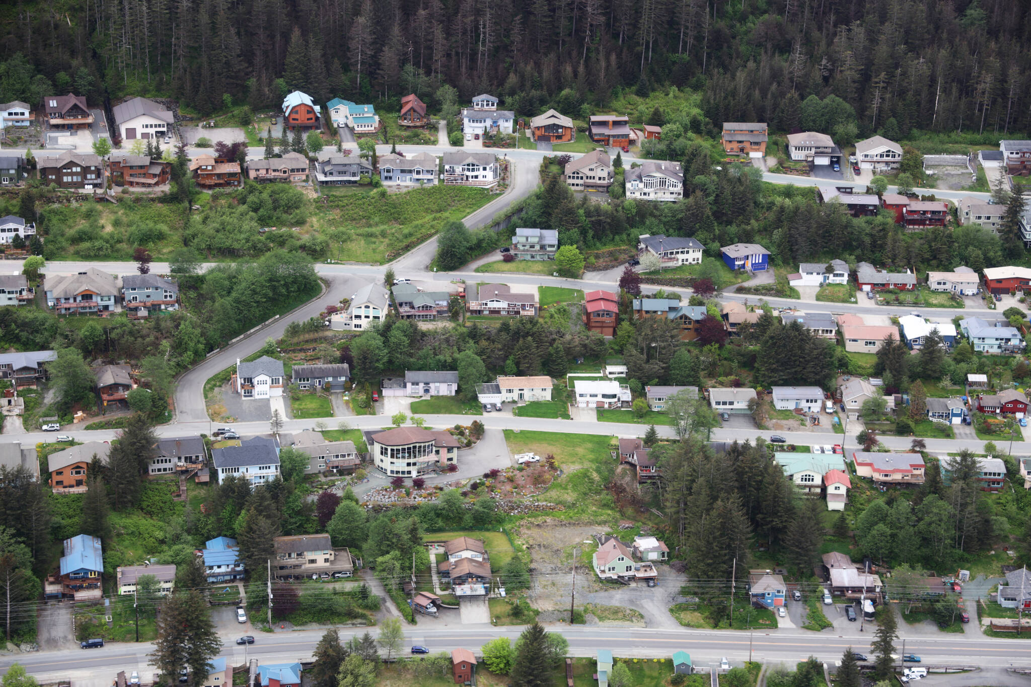 Rows of houses line Douglas Highway in late May. Short-term rental operators in Juneau have until Oct. 8 to register their units with the City and Borough of Juneau before they face a $25 daily fine. (Clarise Larson / Juneau Empire File)