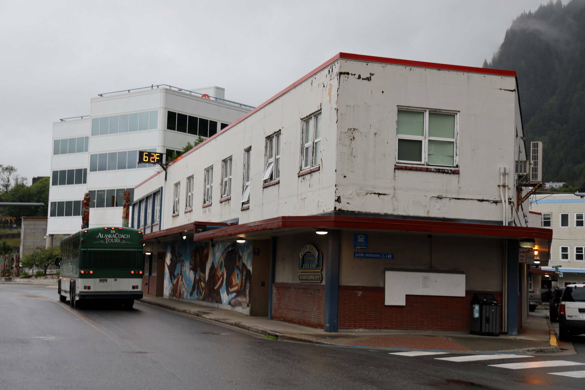 A bus passes by City Hall downtown in late June. (Clarise Larson / Juneau Empire File)