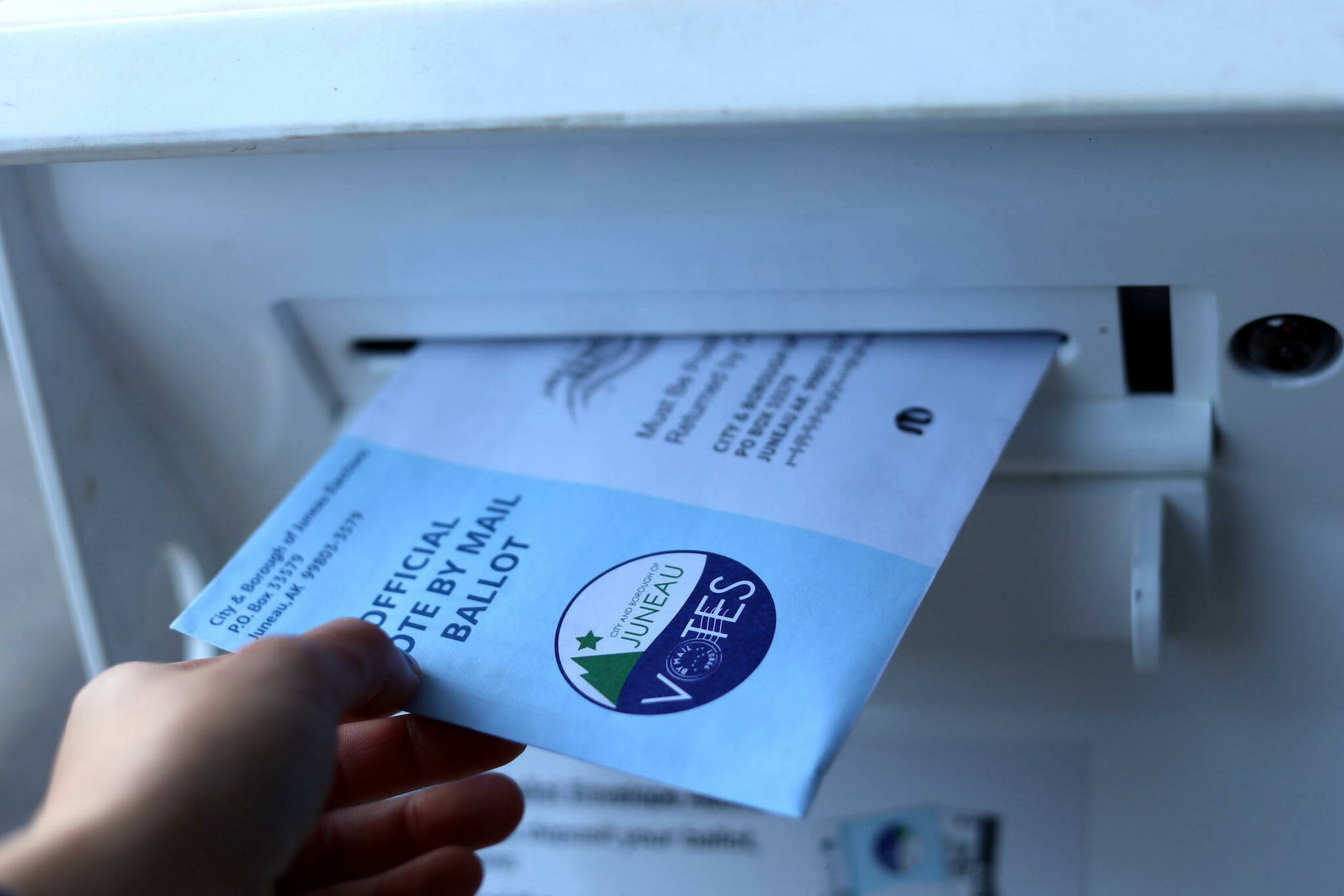 A 2023 municipal election ballot is placed in the drop box at Douglas Library/Fire Hall Community Building. (Clarise Larson / Juneau Empire File)