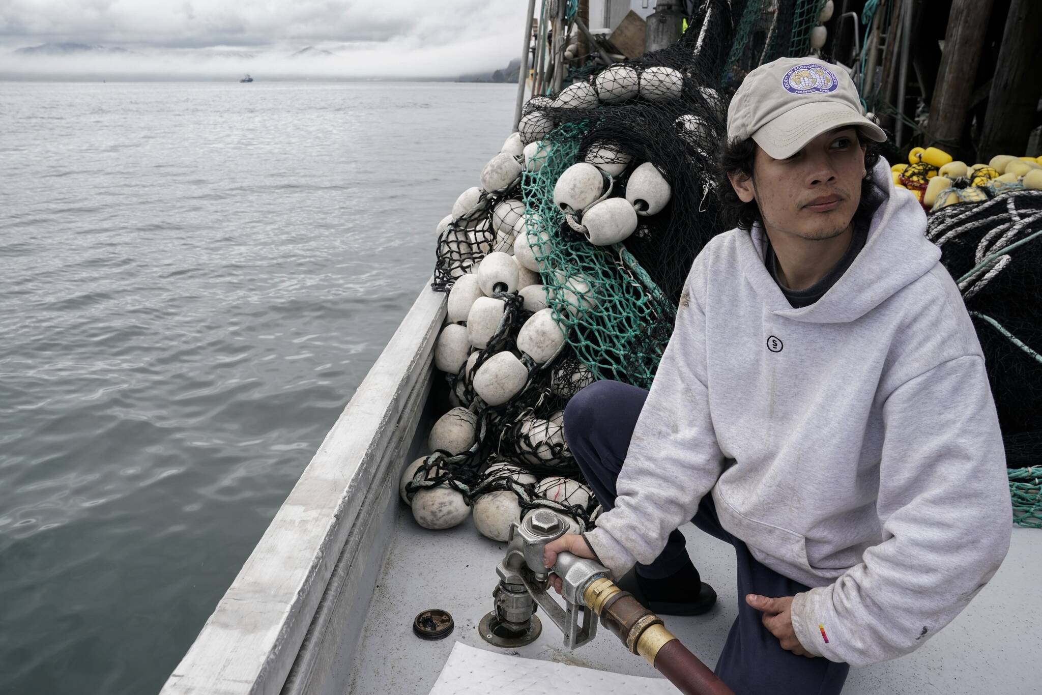 Juan Zuniga, a first-year deckhand on the Agnes Sabine, refuels the boat, Friday, June 23, 2023, in Kodiak, Alaska. For some young people who make the move to Alaska’s coasts, the industry is a way to make quick money, but not a forever job. “This is a pretty far place from where I live,” Zuniga said. “It’s a very big step out of my comfort zone.” (AP Photo/Joshua A. Bickel)