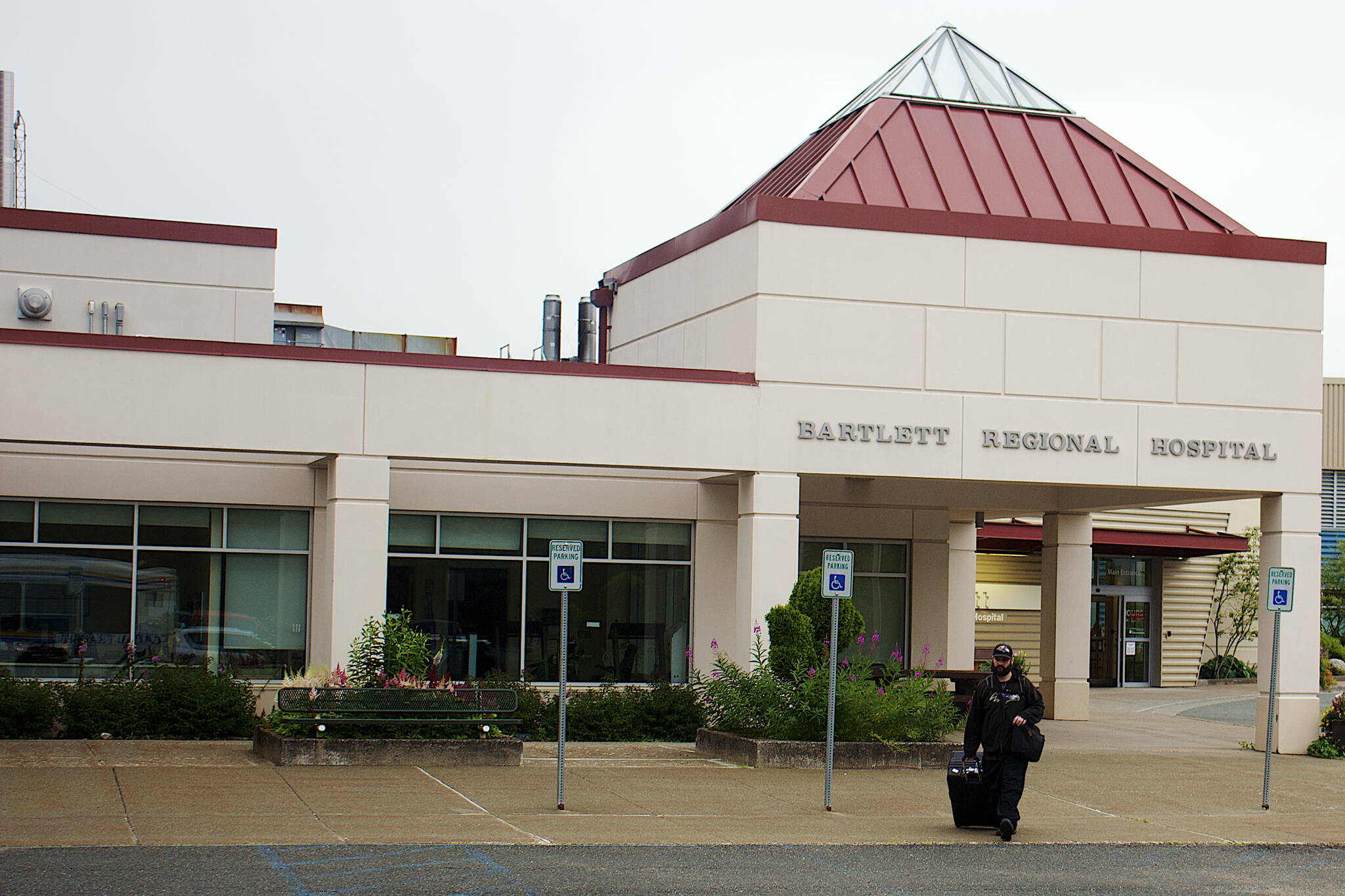 A person departs Bartlett Regional Hospital on July 26, a day after a board of directors meeting raised issues about the hospital’s leadership and quality of care, with then-CEO David Keith resigning a week later. (Mark Sabbatini / Juneau Empire File)