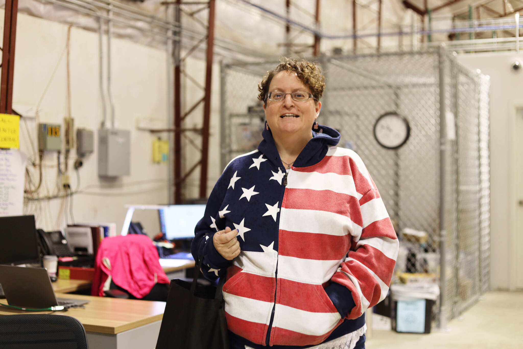 City and Borough of Juneau Clerk Beth McEwen shows off her Election Day attire after returning from the rain outside at the CBJ ballot processing center Tuesday morning. (Clarise Larson / Juneau Empire)