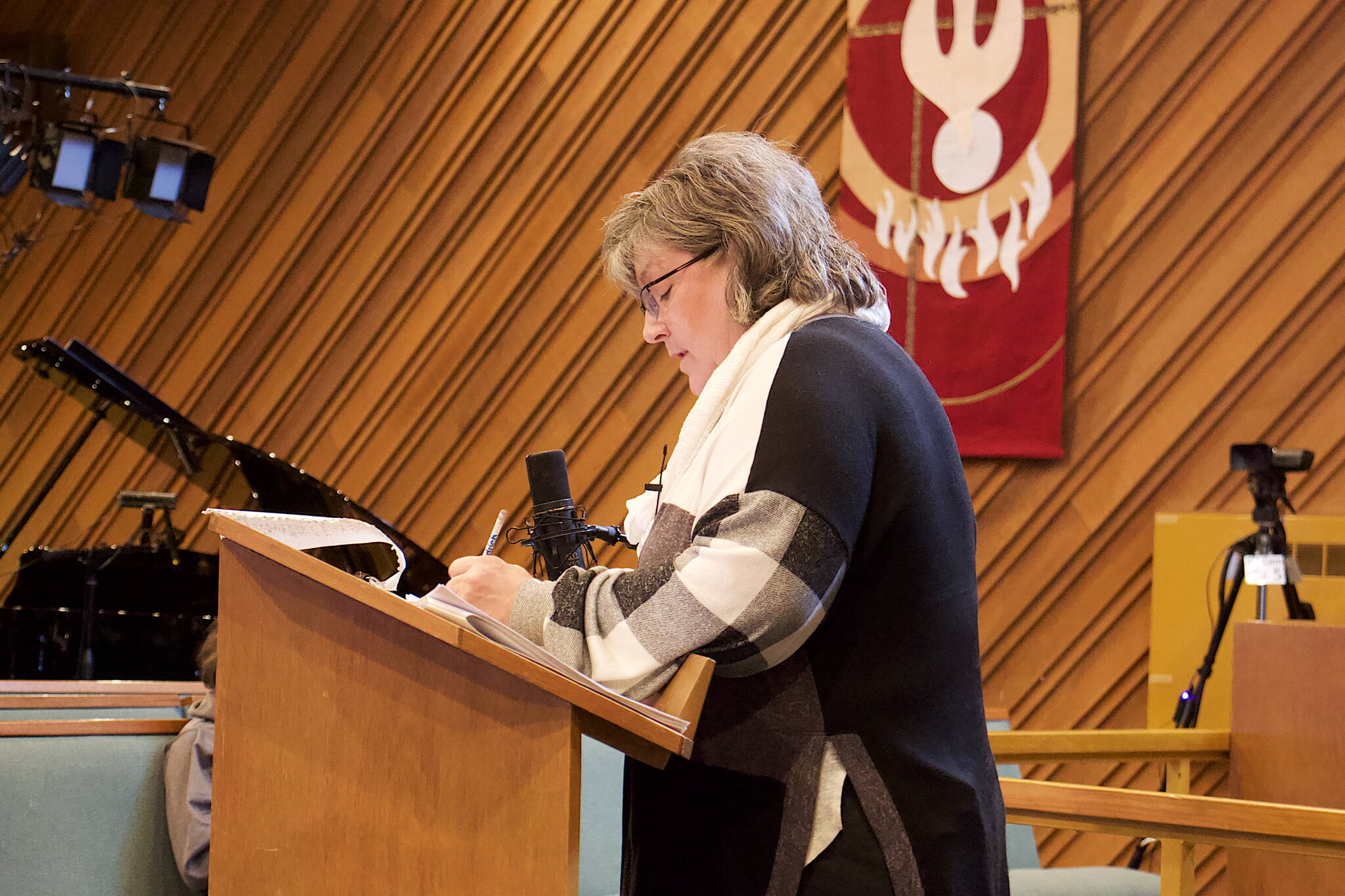 Resurrection Lutheran Church President Karen Lawfer tallies votes during a congregation meeting Sunday to determine if the church will make itself available to host the winter warming shelter again this year. (Mark Sabbatini / Juneau Empire)