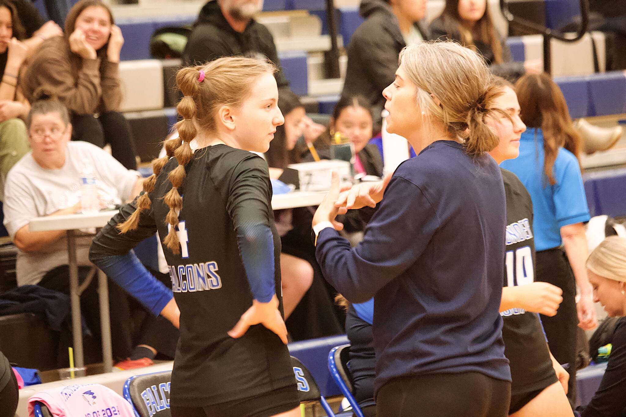 Thunder Mountain High School volleyball coach Julie Herman confers with Jenna Dobson during a timeout in Saturday’s game against Mt. Edgecumbe High School at TMHS. (Mark Sabbatini / Juneau Empire)