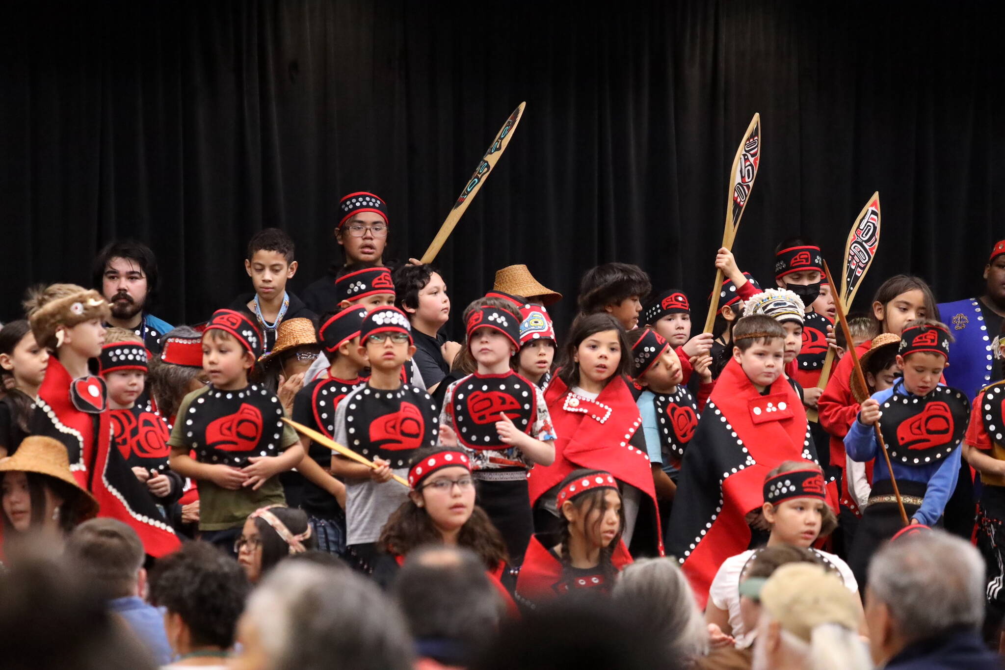 Students from the Tlingit Culture Language and Literacy program sing and dance on stage during a healing event on Indigenous Peoples’ Day on Monday to acknowledge and accept an apology of the closure of Juneau’s Memorial Presbyterian Church in 1962. (Clarise Larson / Juneau Empire)