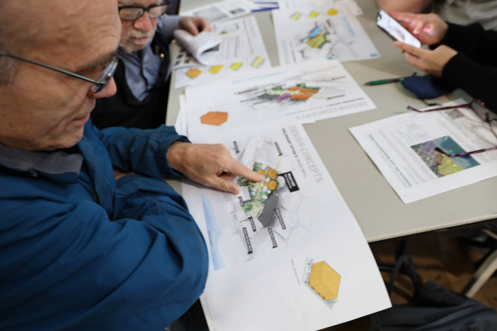 Tony Tengs points to his previous home while looking at the new design concepts for the Telephone Hill redevelopment project that were presented Wednesday evening at the Juneau Arts and Culture Center. (Clarise Larson / Juneau Empire)
