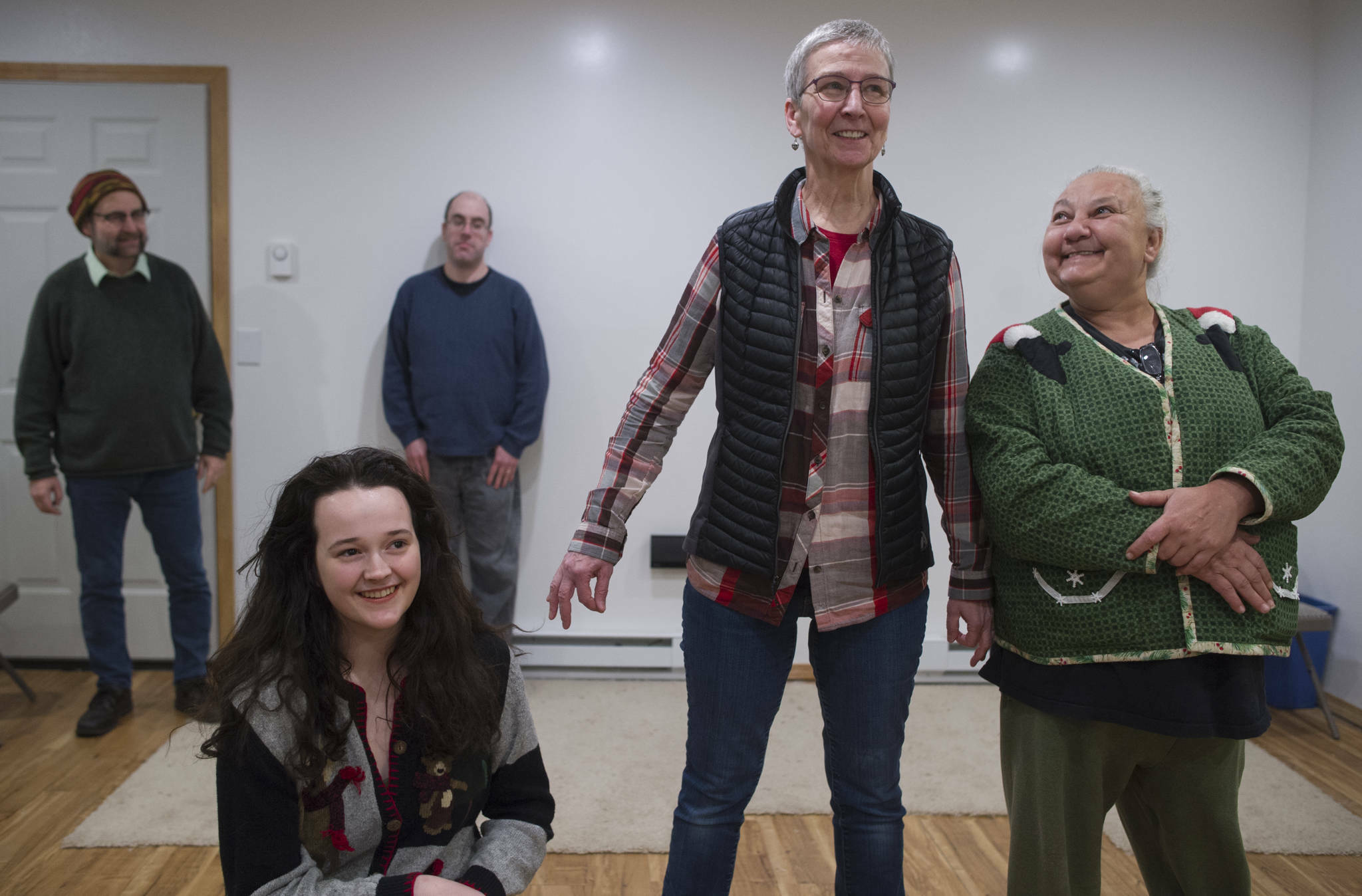Rhoda Walker, right, Sharon Early, and Audrey Kohler work on their improvisation as Mike Christenson, left, and Seth Caron prepare to enter during a rehearsal at Christenson’s house on Thursday, Dec. 21, 2017. Kohler, now a Seattle resident, is returning as part of a nine-person group to perform an improv comedy show at Crystal Saloon on Friday. (Michael Penn / Juneau Empire File)