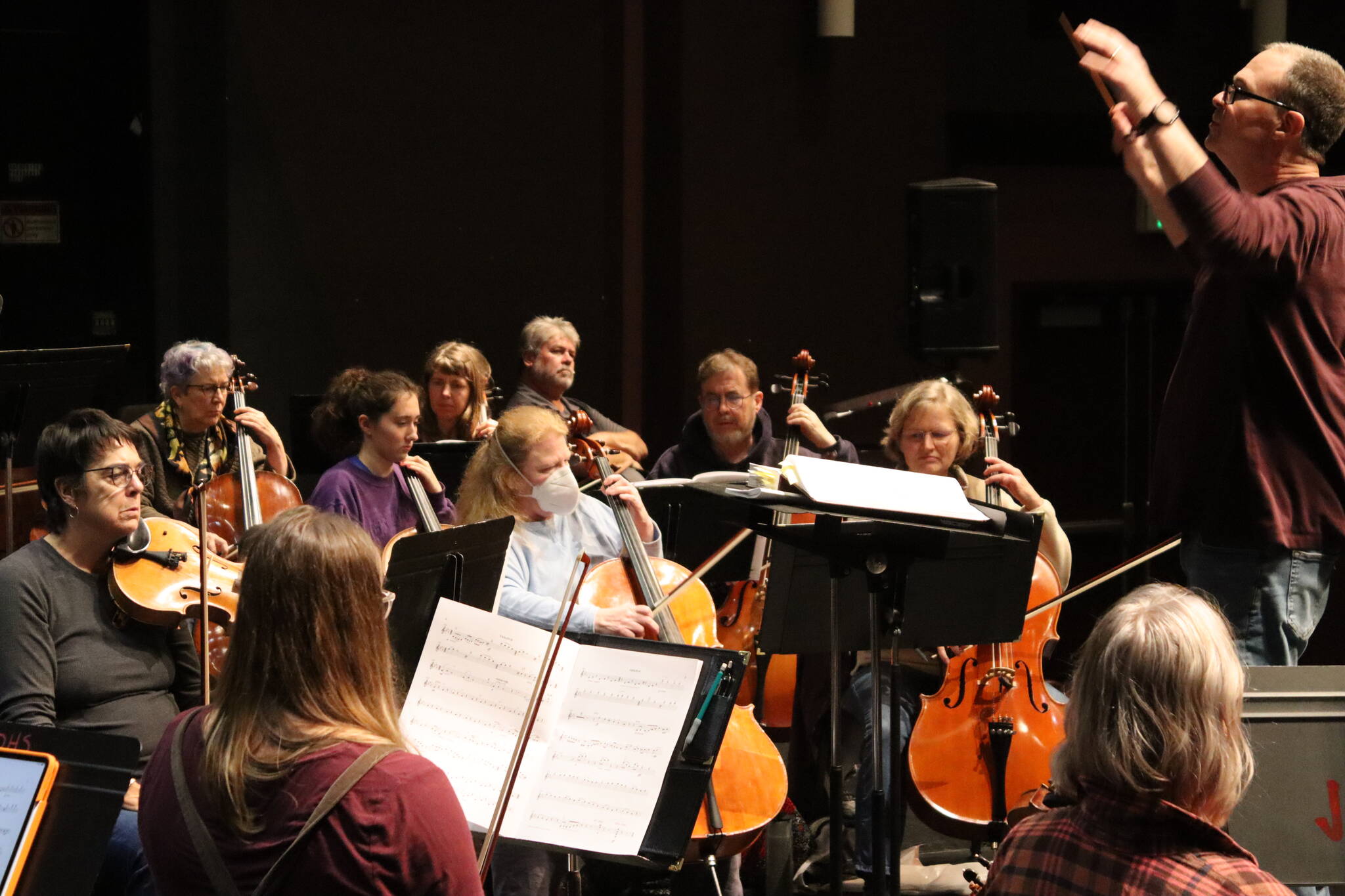 Christopher Koch, musical director for Juneau Symphony, faces members of the viola and cello sections during rehearsals of “Candide” Tuesday evening at Juneau-Douglas High School: Yadaa.at Kalé. Performances at JDHS are scheduled Saturday at 7:30 p.m. and Sunday at 3 p.m. (Meredith Jordan/ Juneau Empire)