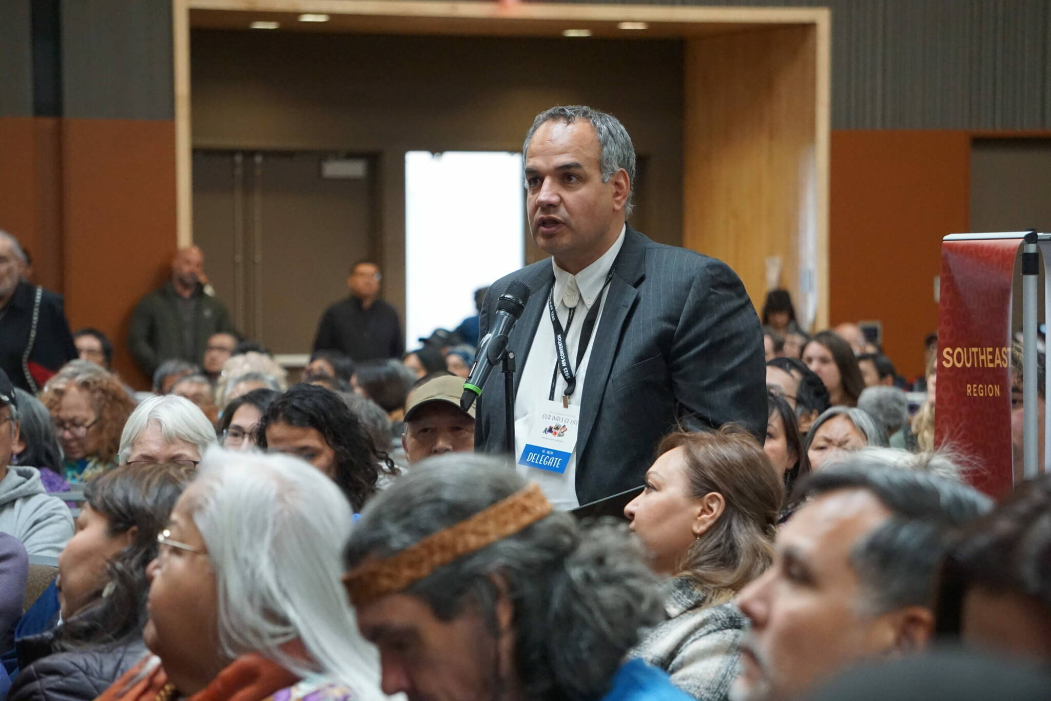 Curt Chamberlain, an attorney who grew up practicing subsistence fishing in Aniak, argues at Friday’s Alaska Federation of Natives convention for changes to federal law to protect Native subsistence harvests. Chamberlain was one of the speakers participating in a floor session on the subject. (Photo by Yereth Rosen/Alaska Beacon)