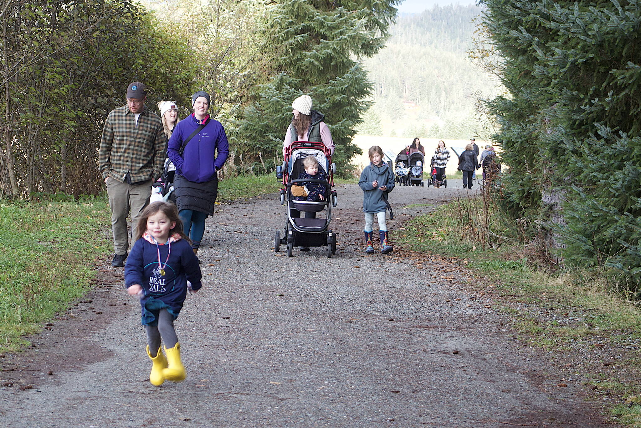 Lily Levy, 3, dashes ahead of her family during the one-mile walk portion of the second annual Real Talk Walk/Run on Saturday at the Airport Dike Trail. (Mark Sabbatini / Juneau Empire)