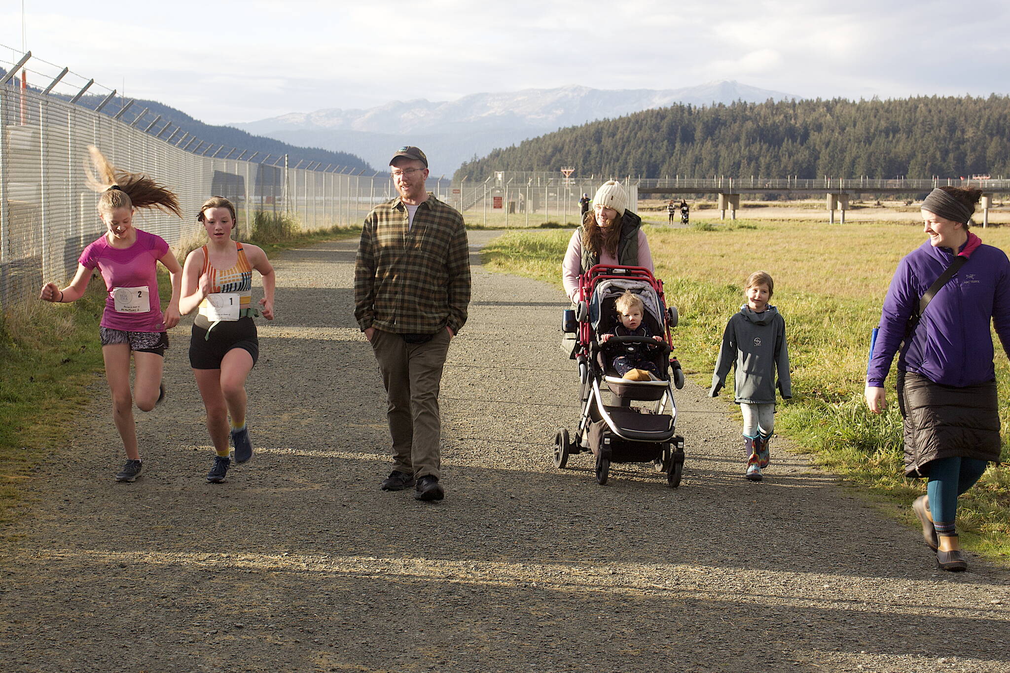 Runners and walkers of all ages cross the finish line of the second annual Real Talk Walk/Run on Saturday at the Airport Dike Trail. (Mark Sabbatini / Juneau Empire)