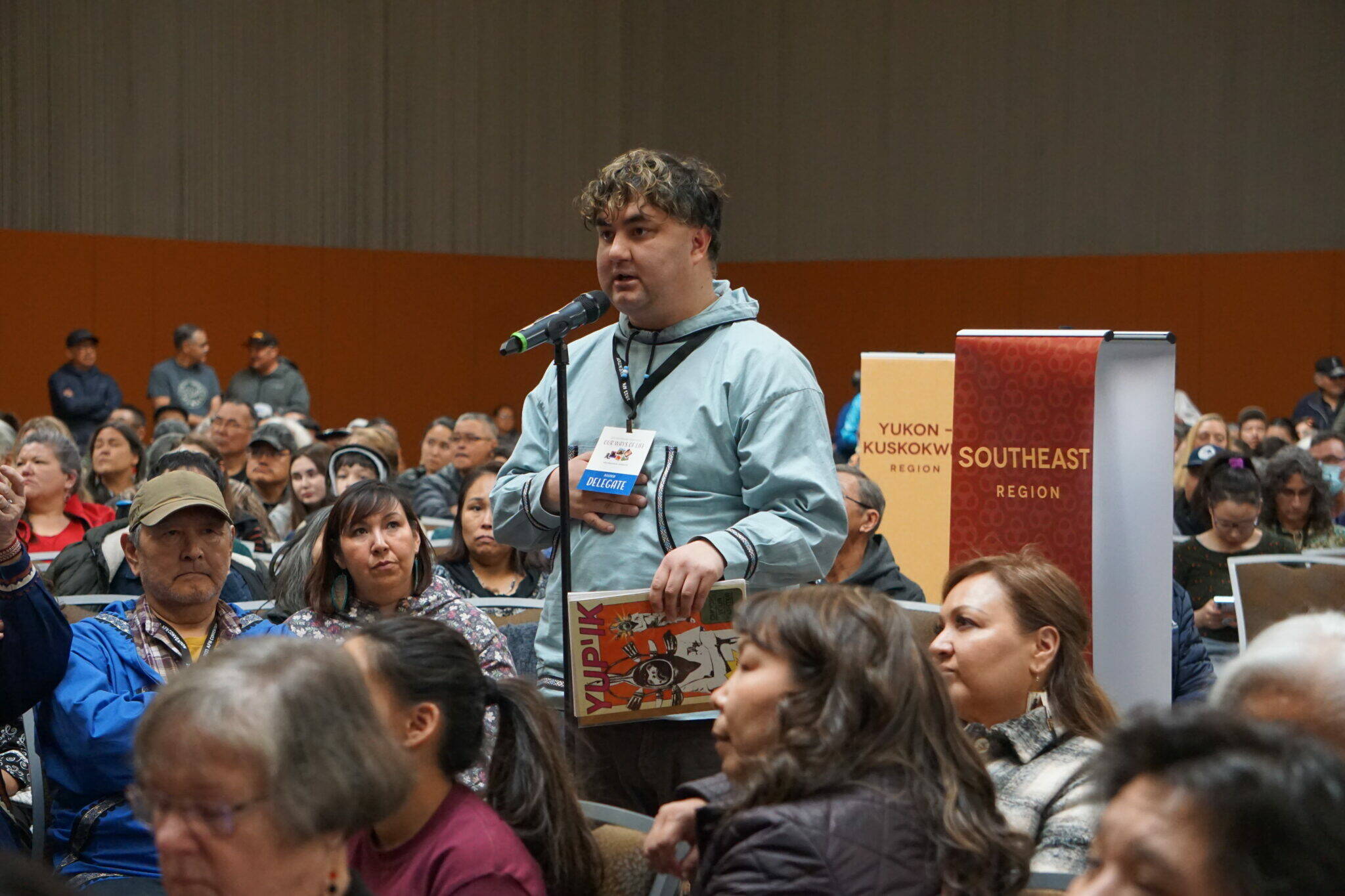 Jonathan Samuelson, chair of the Kuskokwim River Inter-Tribal Fish Commission, speaks Friday at the Alaska Convention of Natives convention about the effects of salmon crashes in his region. (Photo by Yereth Rosen/Alaska Beacon)
