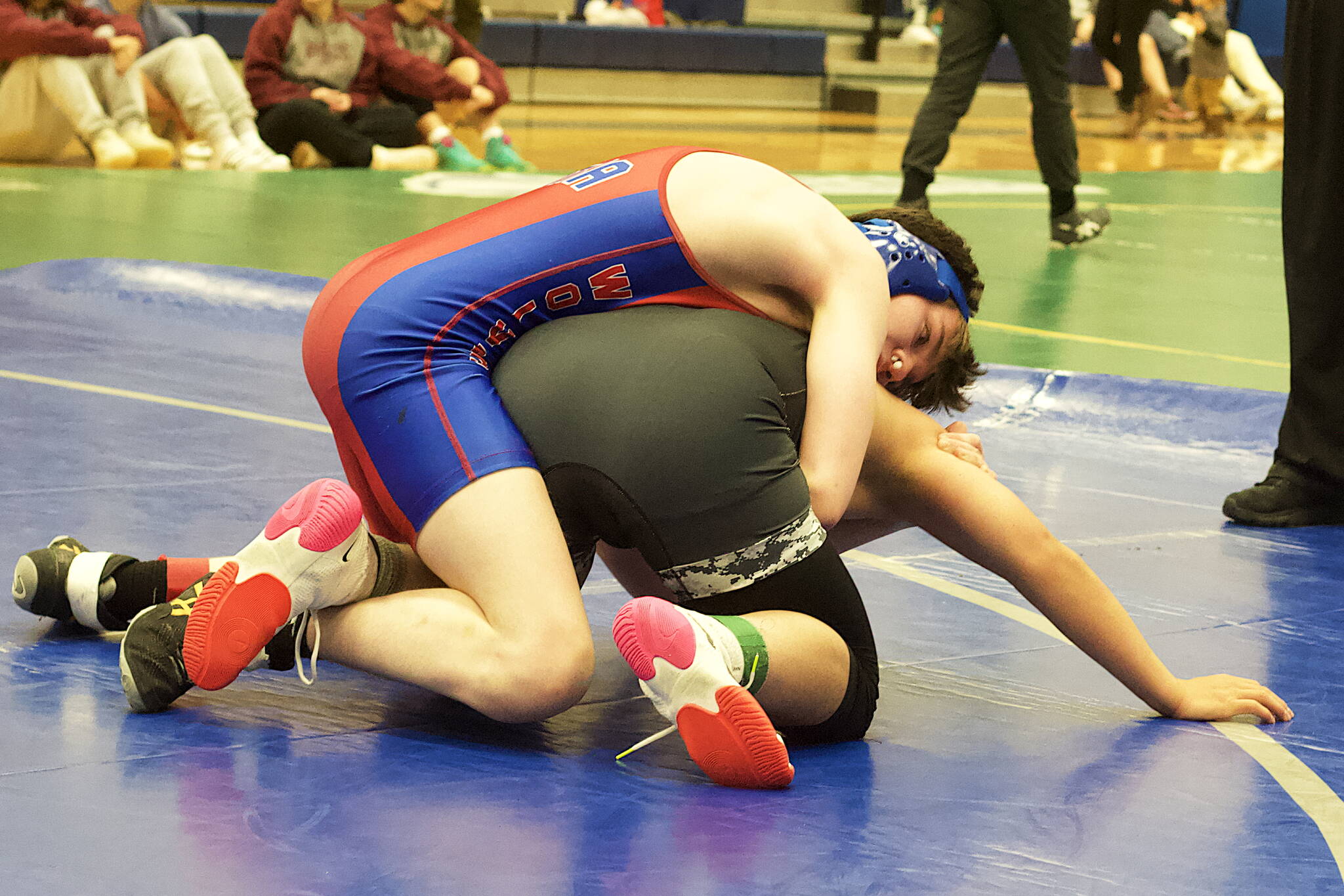 Killan Hammock of Sitka High School, top, after suffering a nose injury, tries to pin Gunner Niere of Thunder Mountain High School during their third-place match in the Southeast Showdown at TMHS on Saturday. Niere won the match to claim third place in the 135-pound division. (Mark Sabbatini / Juneau Empire)