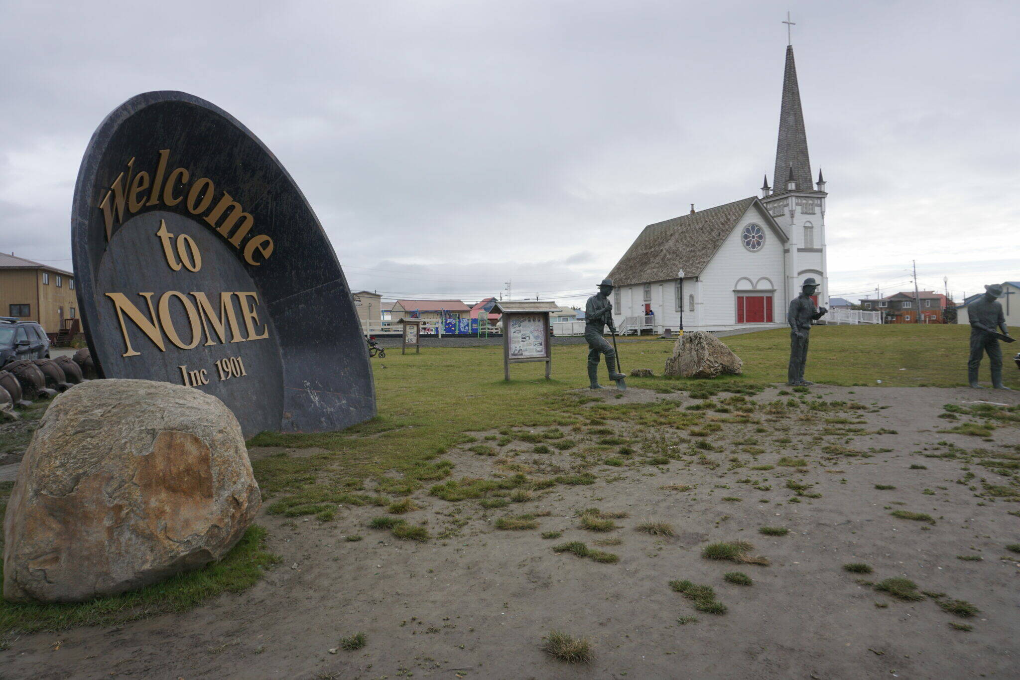 Nome’s Anvil City Square, with a giant gold pan and statues of the “Three Lucky Swedes” whose discovery kicked off the 1899 Gold Rush, is seen on Sept. 5, 2021. (Photo by Yereth Rosen/Alaska Beacon)