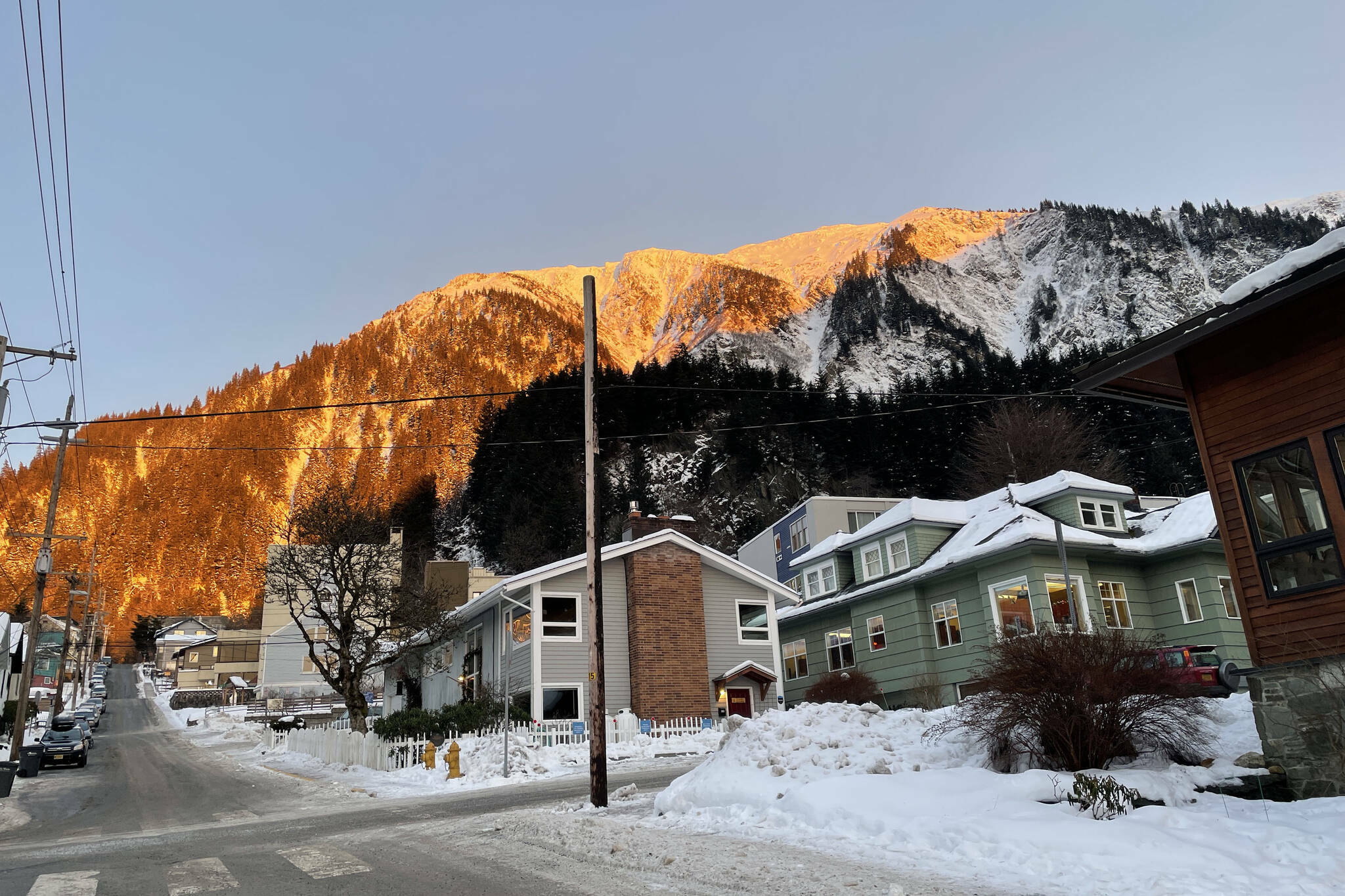 Sunlight is cast over part of Mount Juneau on Dec. 16, 2021. (Michael S. Lockett / Juneau Empire File)