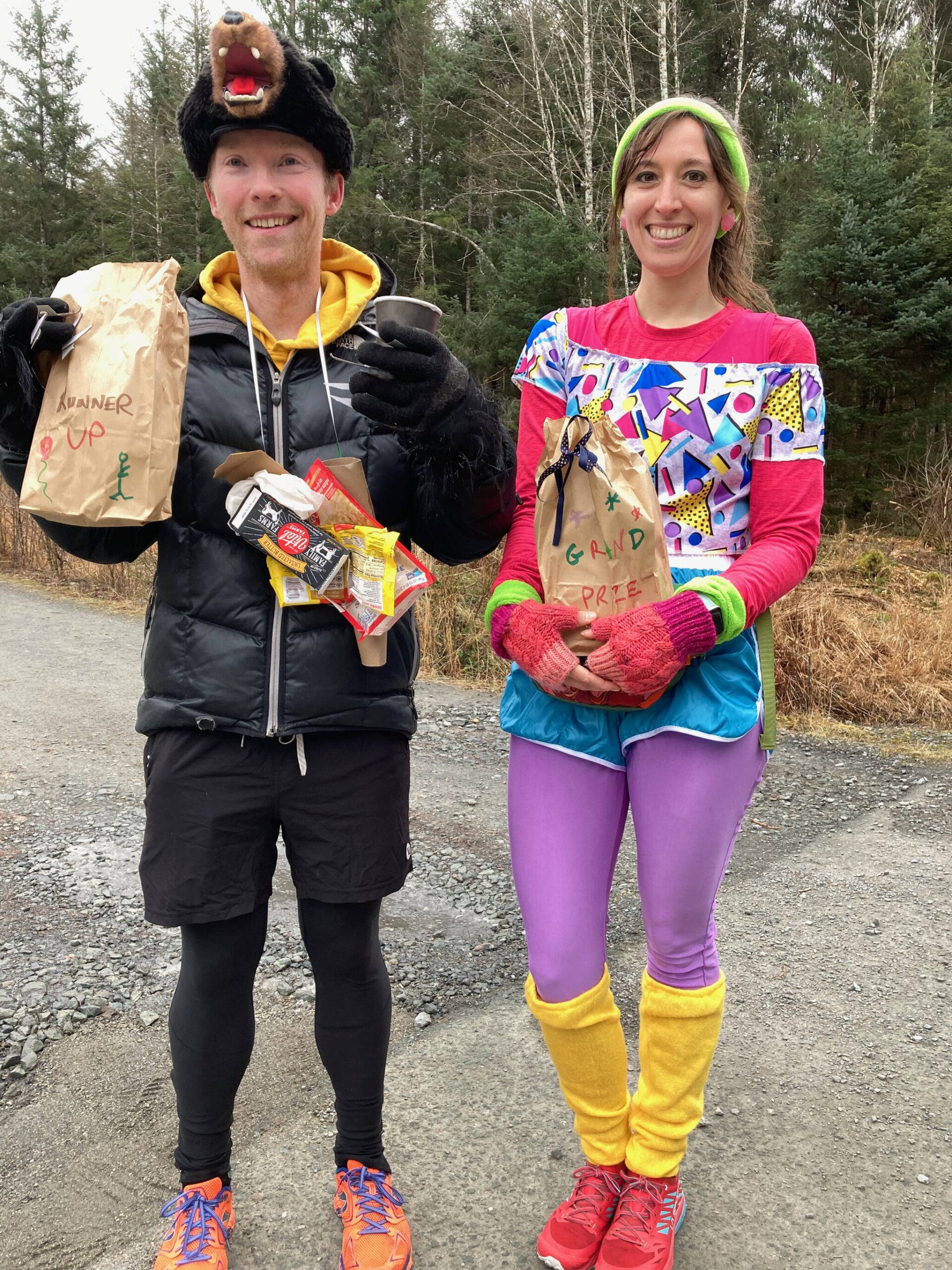 Juneau garbage bear Quinn Tracy, left, was runner up to ‘80s aerobic queen Christy Gentemann, right, for the Costume Contest win during the Halloween Half Marathon on Saturday. (Klas Stolpe for the Juneau Empire)