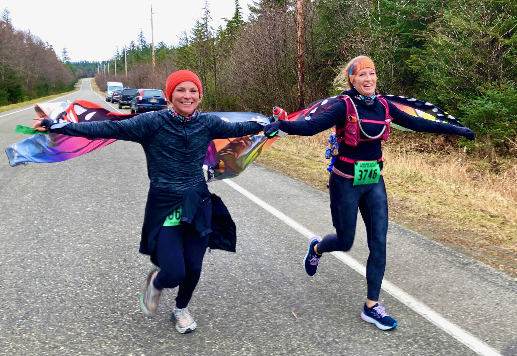Suzanne Morris, left, and Melissa Anderson finish the Halloween Half Marathon on Saturday. (Klas Stolpe for the Juneau Empire)