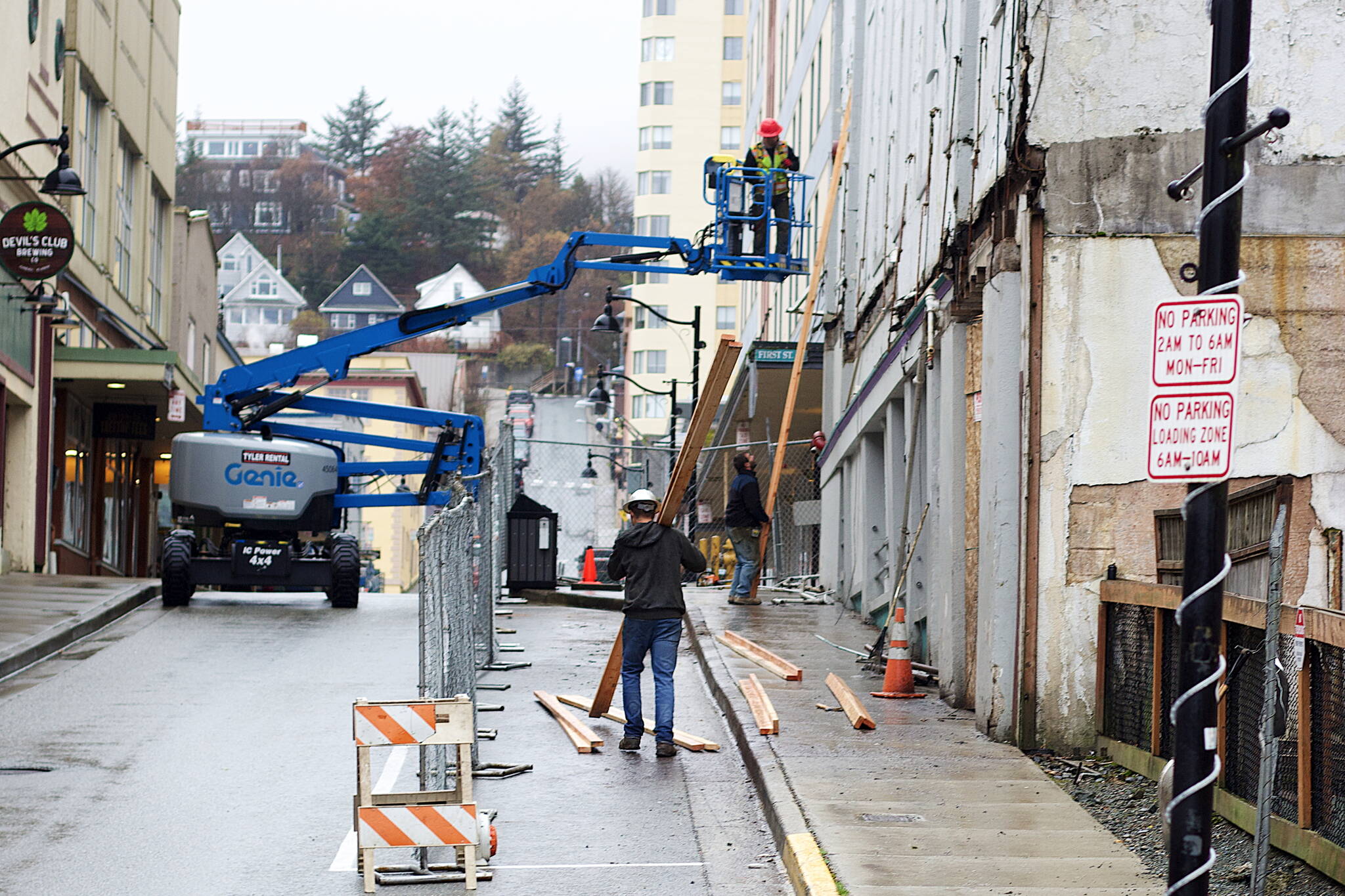 Workers remove awning from the old Elks Lodge building at 109 S. Franklin St. at midday Monday. While heavy construction equipment is parked next to the structure, the owner says no decision about the fate of the building has been made yet. (Mark Sabbatini / Juneau Empire)