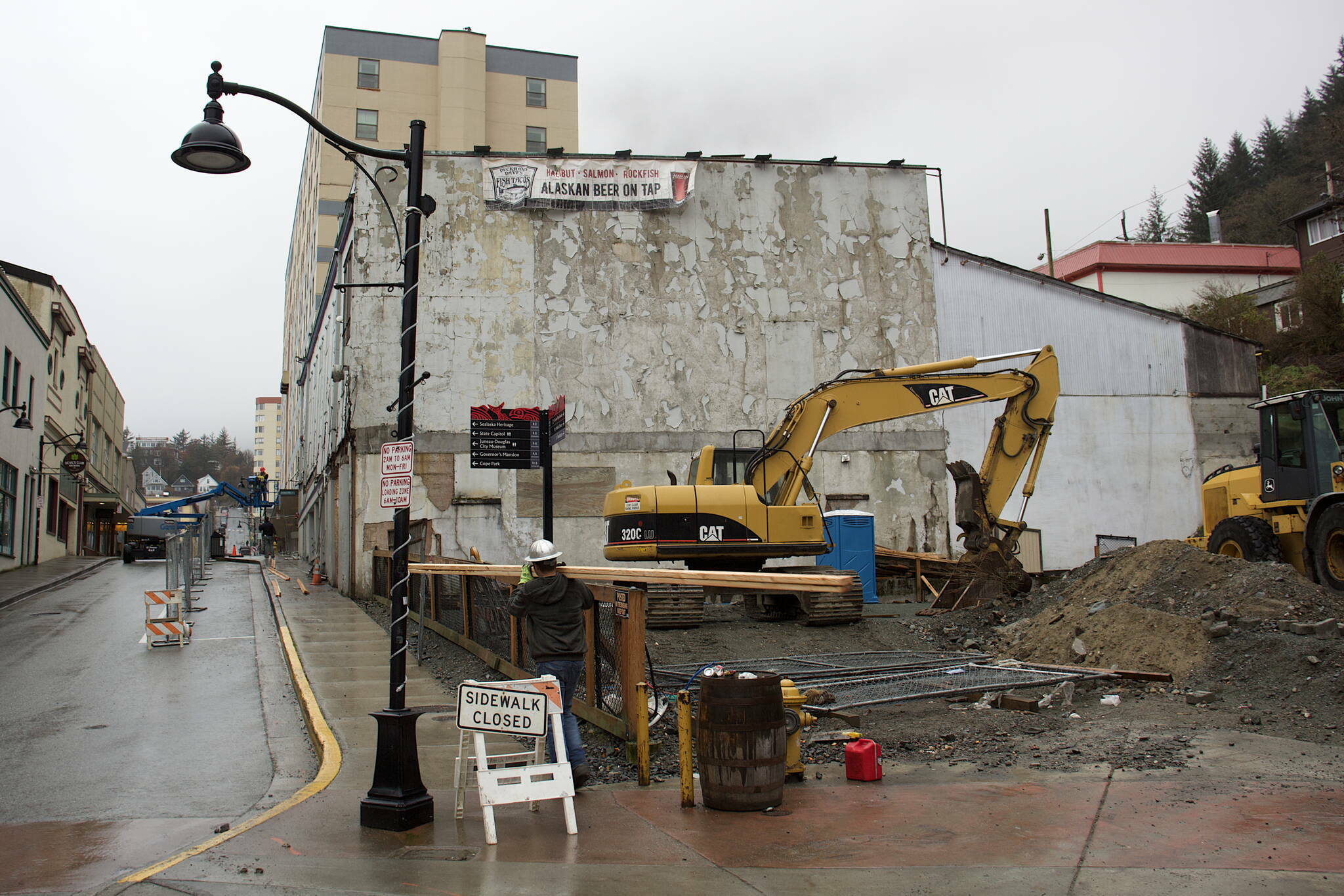 Heavy equipment is parked next to the old Elks Lodge building at 109 S. Franklin St. when an add-on structure to the original 1908 building was still standing. On Wednesday afternoon that part of the structure and a wall portion of the original building had been demolished. (Mark Sabbatini / Juneau Empire)