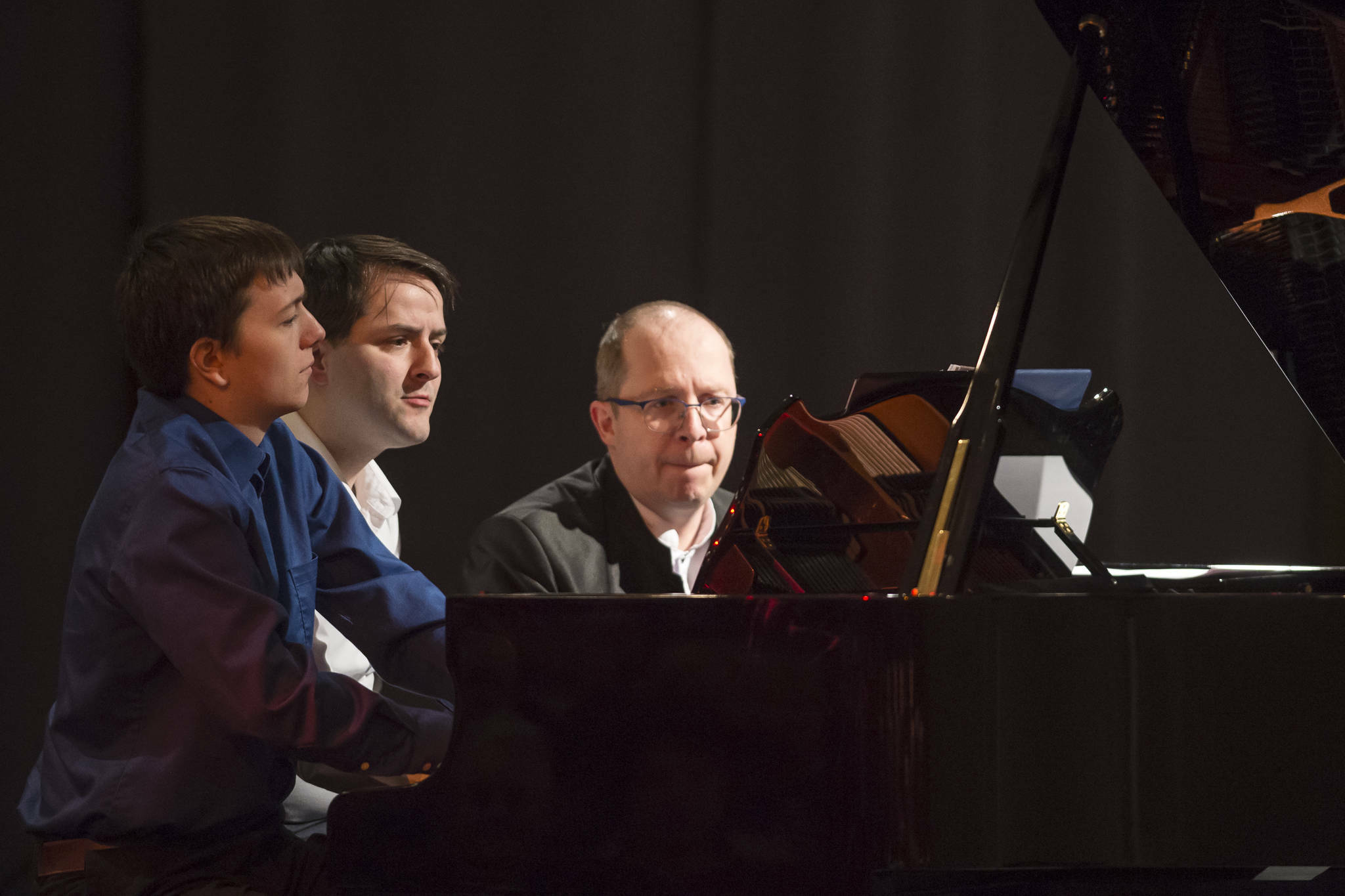 Michael Penn / Juneau Empire File
Kyle Farley-Robinson, left, Jon Hays, center, and Dr. Alexander Tutunov play “Romance And Waltz For Six Hands Piano” by Sergei Rachmaninoff during the Juneau Piano Series featuring Dr. Tutunov at the Juneau Arts and Culture Center on Friday, Jan. 18, 2019.