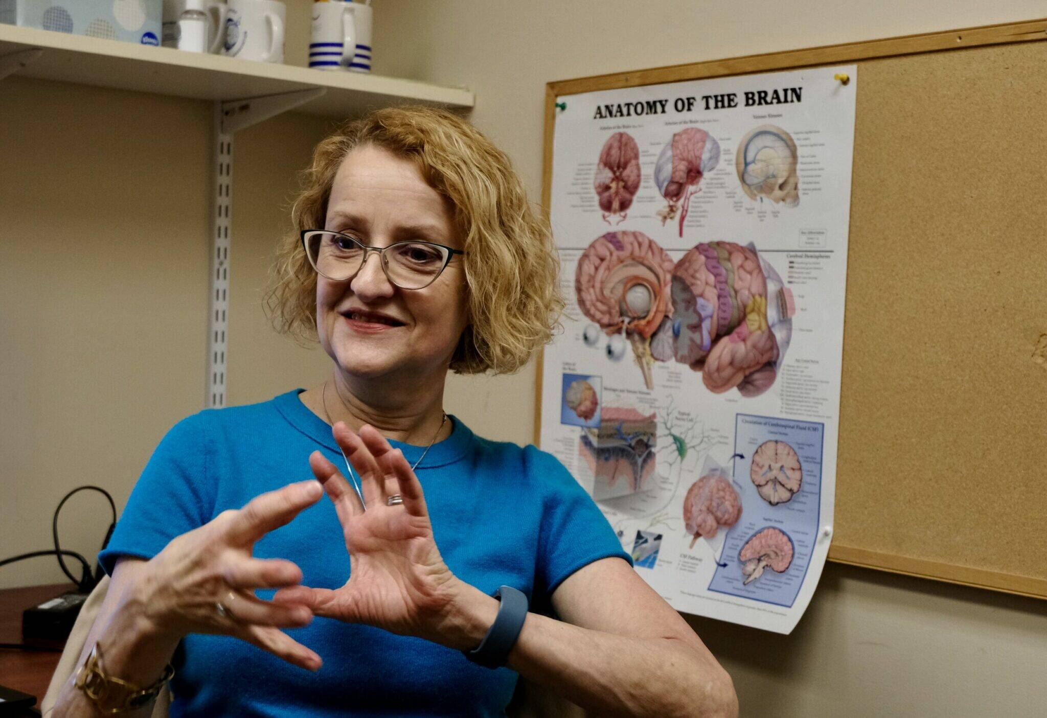 Patty Raymond-Turner, a coordinator for the Brain Injury Council of Alaska, demonstrates what happens to the brain when it is injured, on Sept. 26 in Anchorage. (Photo by Claire Stremple/Alaska Beacon)