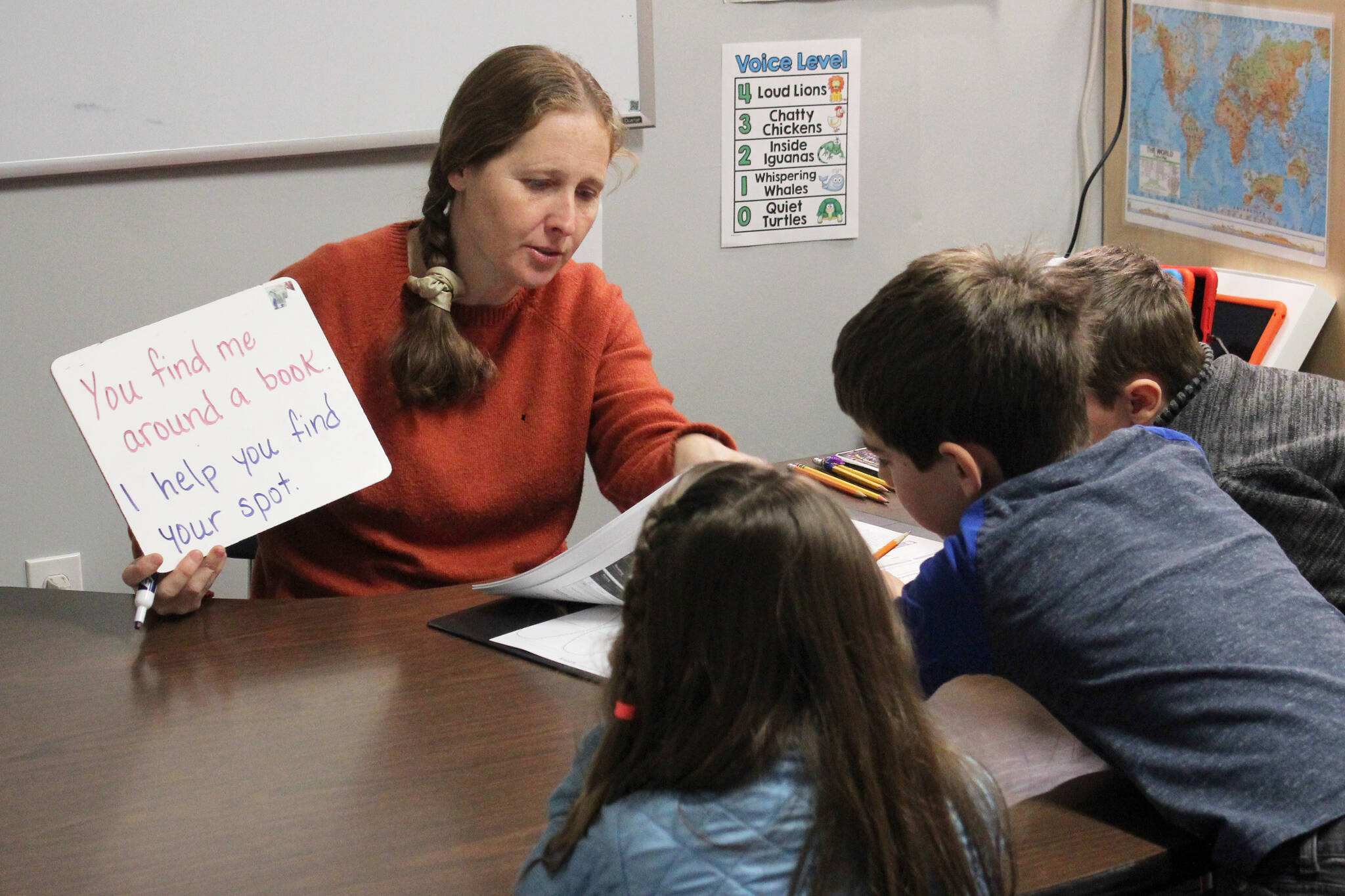 Jennifer Medley (left) practices literacy skills with students at Fireweed Academy on Tuesday, Oct. 17, 2023, in Homer, Alaska. (Ashlyn O’Hara/Peninsula Clarion)