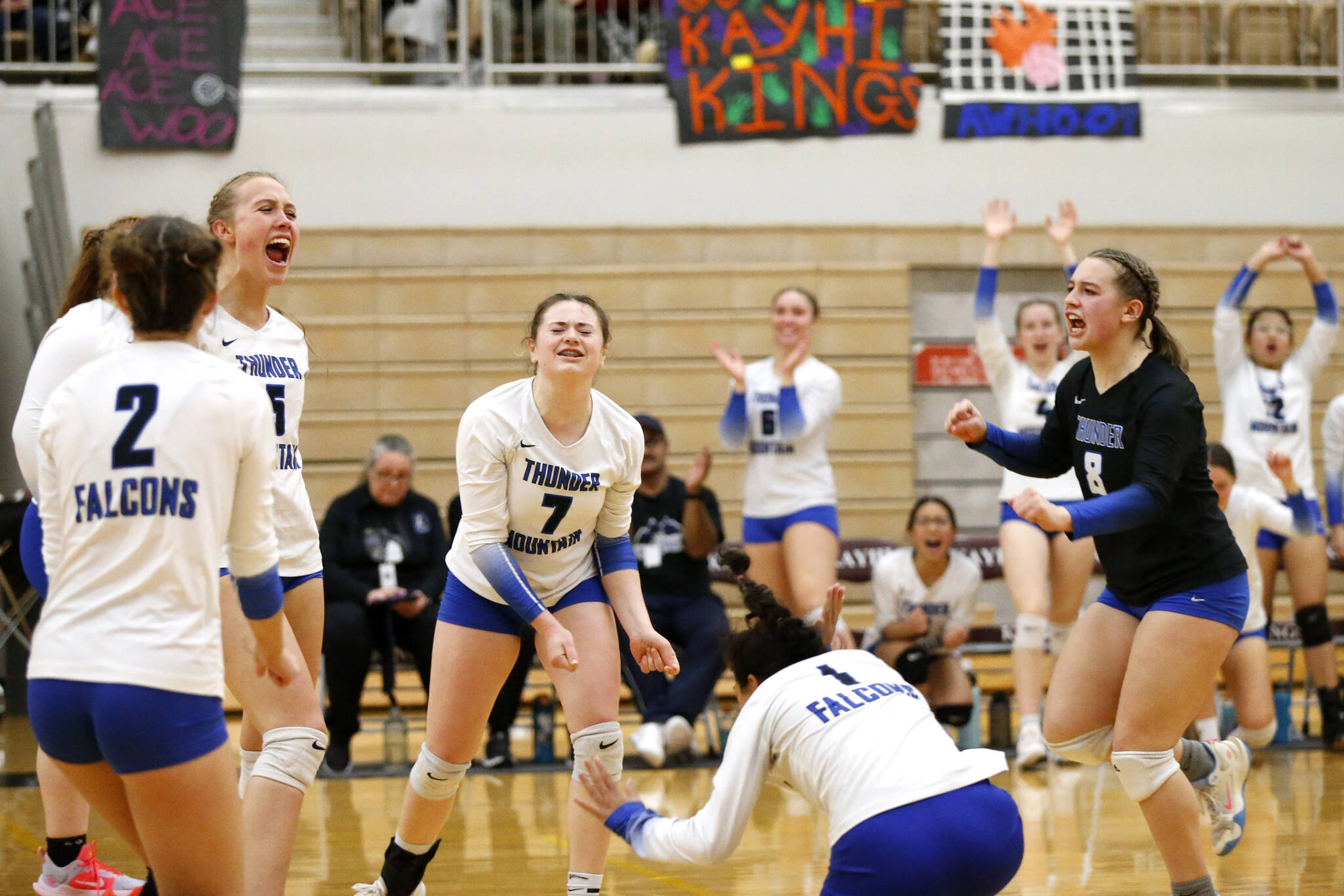 Thunder Mountain High School players celebrate after scoring a point during their 3-1 victory over Ketchikan High School to win the Region V Volleyball Tournament in Ketchikan on Saturday. (Christopher Mullen / Ketchikan Daily News)
