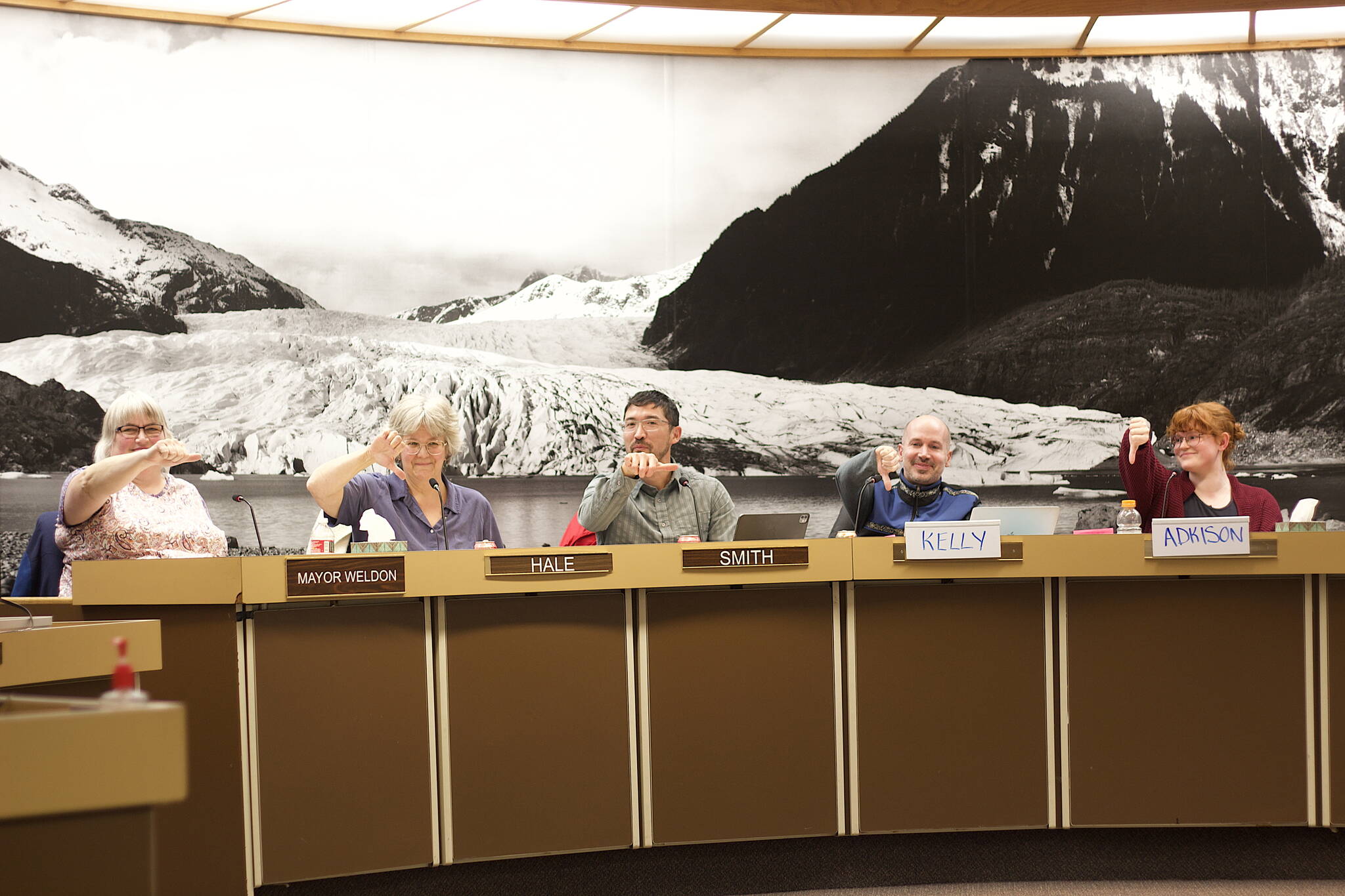 Juneau Assembly members cast an informal vote during a Committee of the Whole meeting Monday night about the volume of cruise tourism they want to see in Juneau in future years. Mayor Beth Weldon (left) and Assembly member Greg Smith (middle) cast neutral votes essentially favoring an as-is approach, while Michelle Bonnet Hale, Paul Kelly and Ella Adkison suggesting they prefer lower numbers than the record 1.66 million passengers that visited this year. Votes by the other four members included one as-is and three “thumbs down,” for a 6-3 vote in favor of the city’s tourism director exploring a strategy for 2026 and beyond that results in fewer annual cruise visitors. (Mark Sabbatini / Juneau Empire)