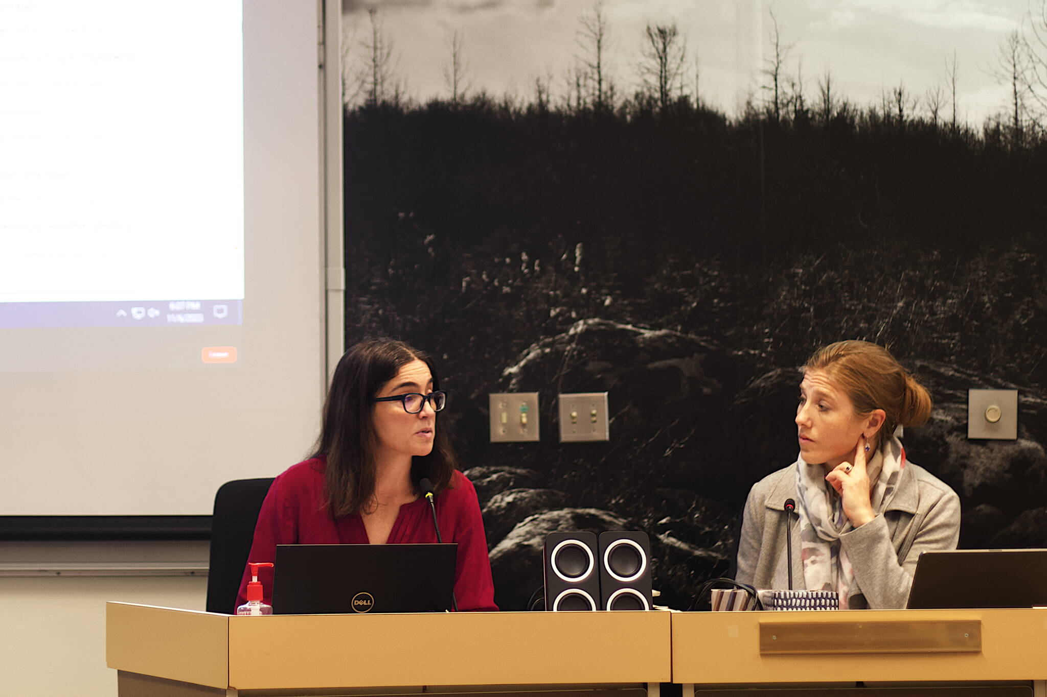 Denise Koch, director of engineering and public works for the City and Borough of Juneau, explains efforts being made to secure various types of flood mitigation funding while City Manager Katie Koester listens during a Juneau Assembly Committee of the Whole meeting Monday night in the Assembly Chambers. (Mark Sabbatini / Juneau Empire)