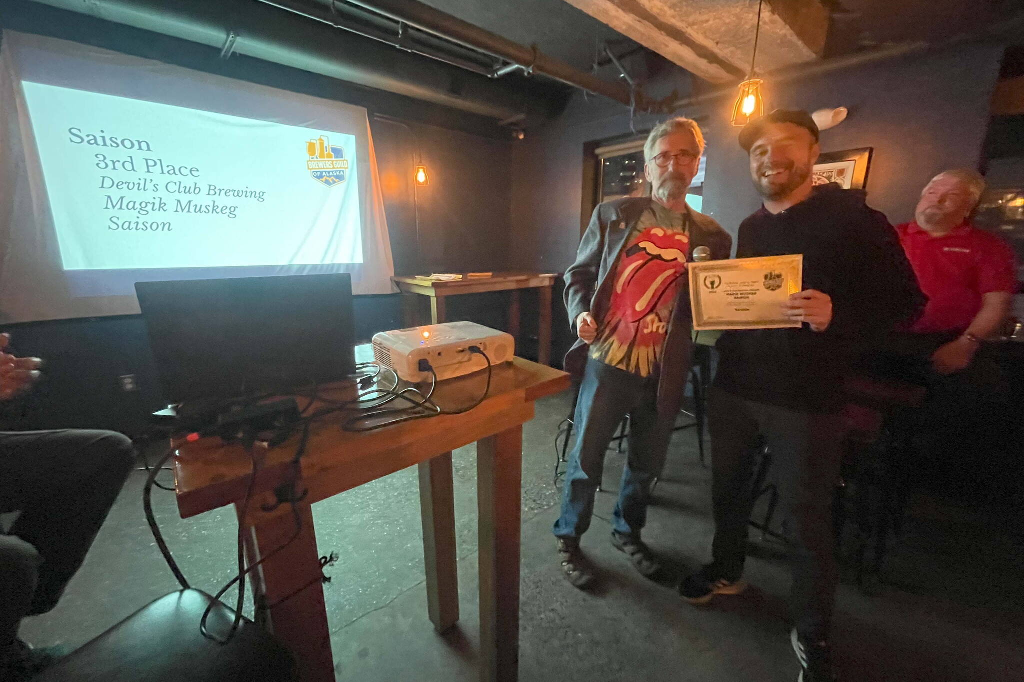 Devil’s Club Brewing Company brewer Trever Held accepts an award at the 2023 AK Beer Awards competition at Williwaw Social in Anchorage on Nov. 3. (Photo courtesy of Brewers Guild of Alaska)