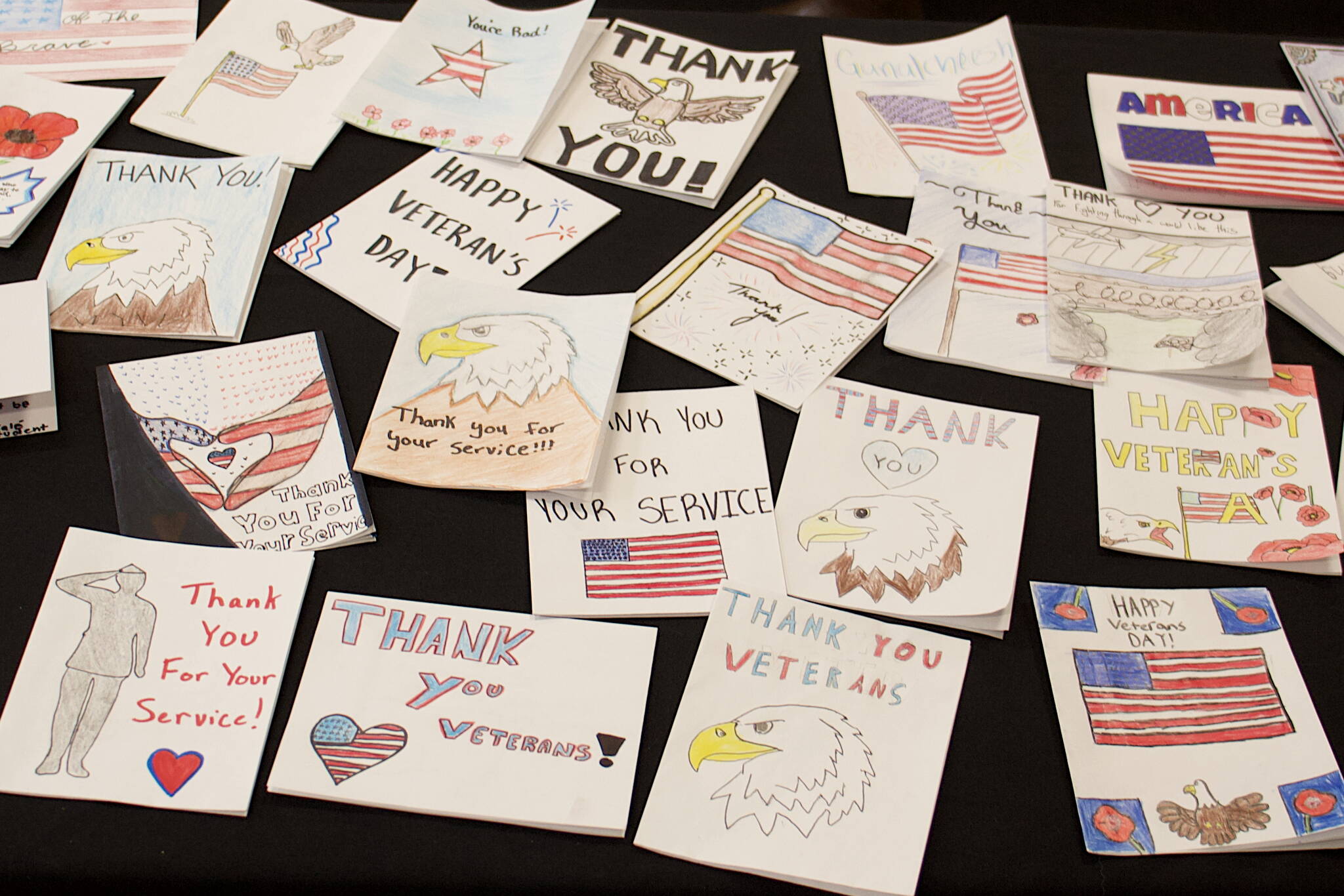 Thank you cards by local youths are displayed on a table at an entrance to Elizabeth Peratrovich Hall during a Veterans Day celebration on Saturday hosted by Southeast Alaska Native Veterans. (Mark Sabbatini / Juneau Empire)